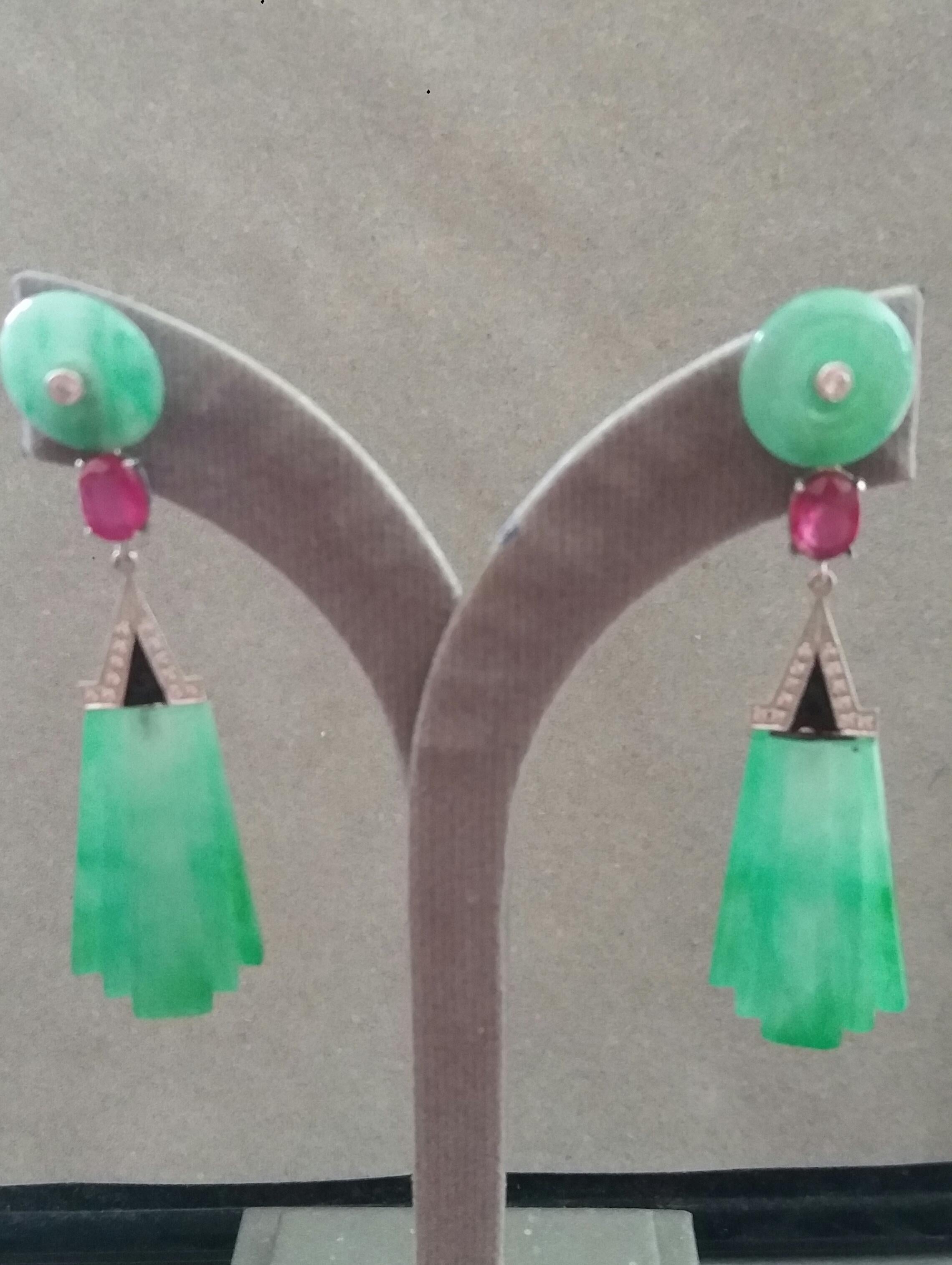 In these classic Art Deco Style earrings we have the tops with 2 Jade discs with small diamonds set in gold in the center ,the middle parts are composed of 2 Oval faceted Rubies measuring 6x8 mm and 2 elements in White Gold, Diamonds and Black