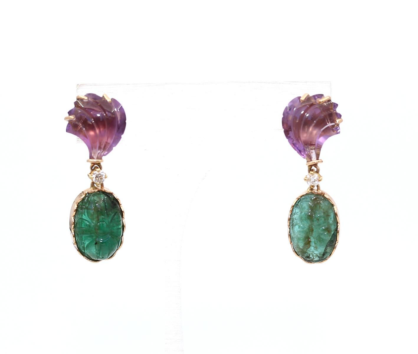 An Art-deco pair of unique hand carved 7  Carats natural Zambian Emerald and 5.5 Carats natural Amethyst dangle earrings. Set in solid 18 K Yellow Gold.  

Just an amazing item with beautiful coloration between the Amethyst and fine green Emeralds