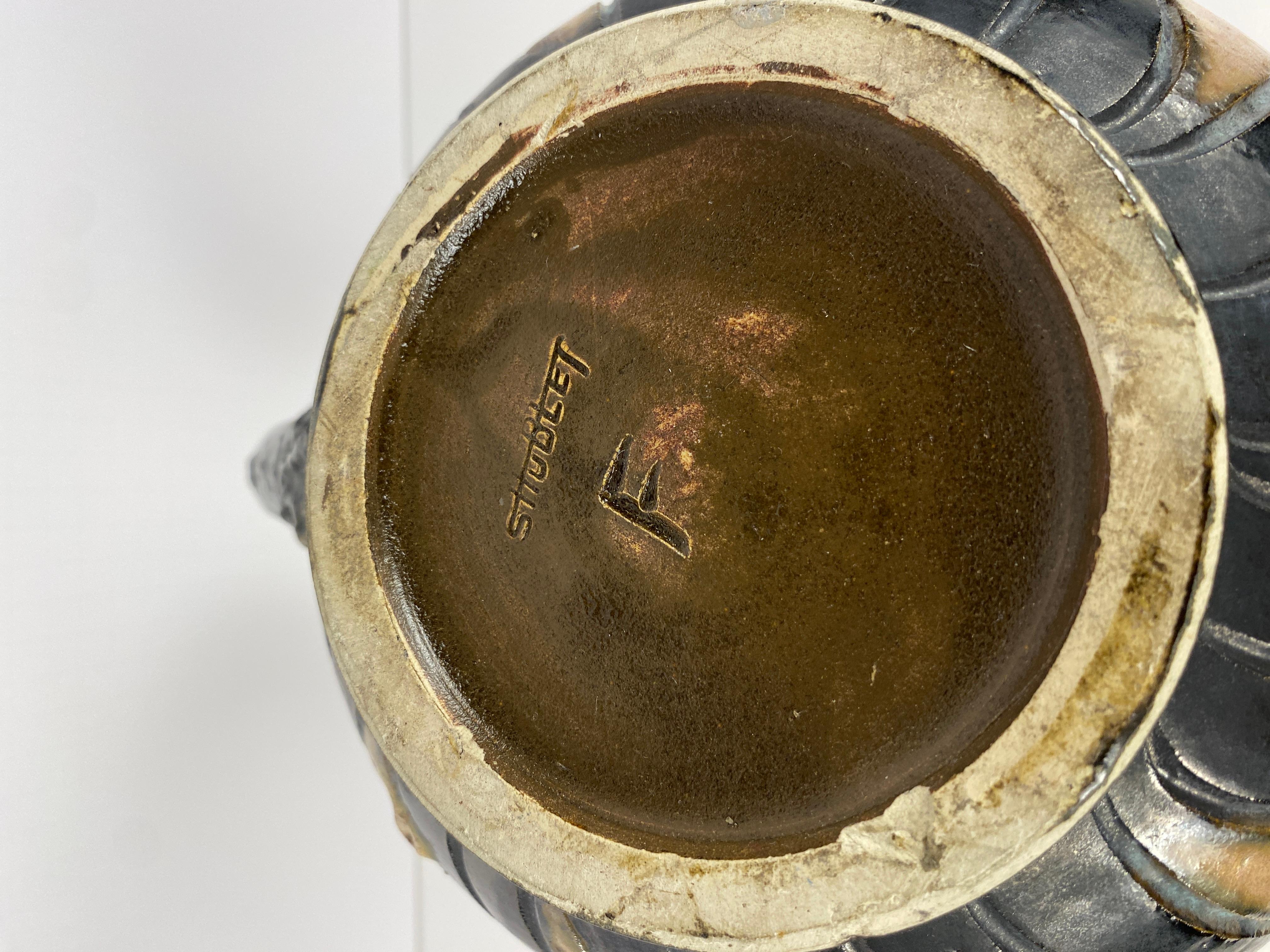 Superbe vase en grès de S. Hublet (Sylvain Hublet). 

Fabriqué à la main, ce récipient présente une surface beige, rose et noire semblable à du granit, accentuée par des chevrons de forme libre sur le dessus et le dessous. Le centre de cette