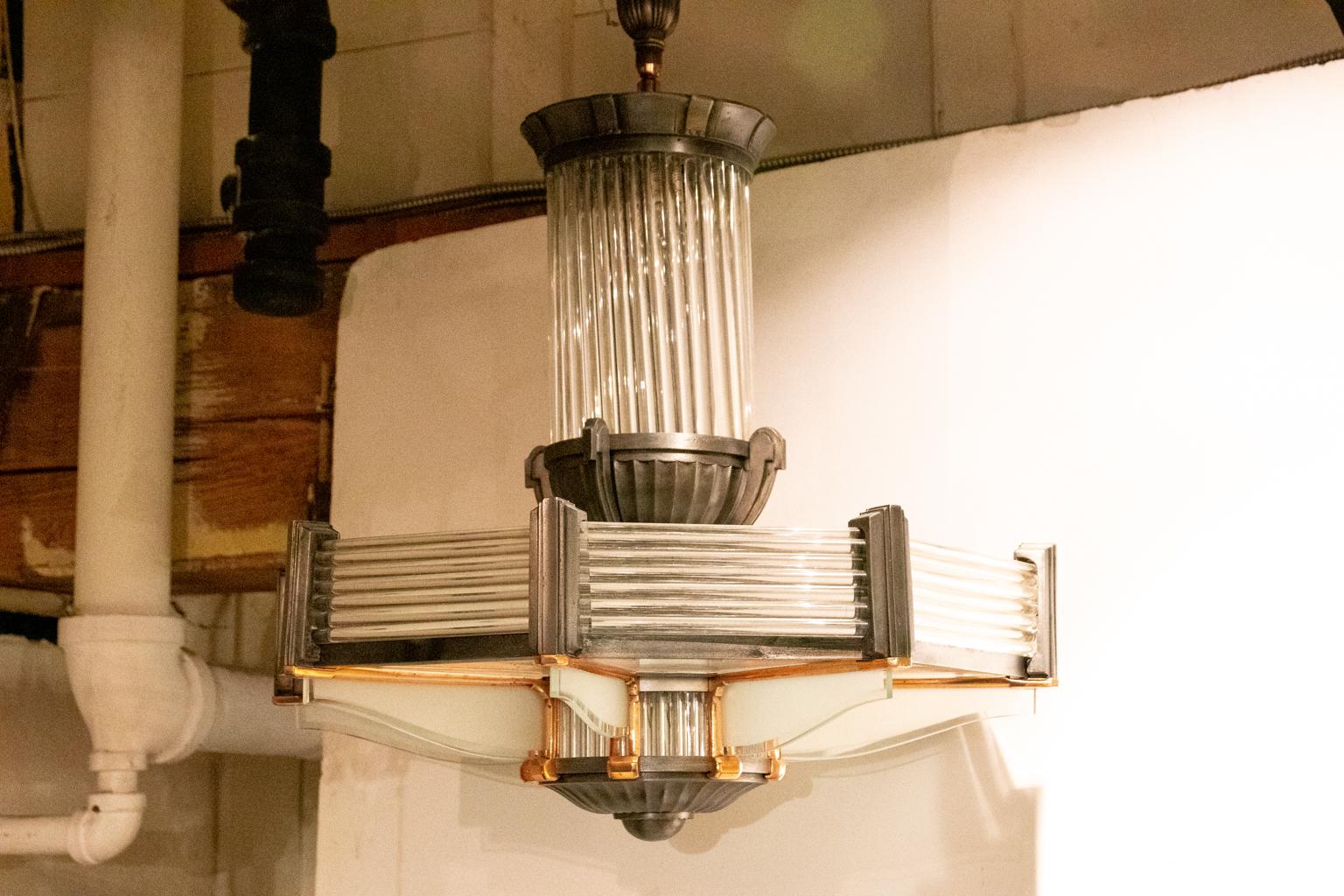 Art Deco style chandelier, circa 1930s. The frame is composed of copper and chrome holds along with glass rods that form a geometric pattern. The lightbulbs are not exposed. Shades not included. Please note of wear consistent with age of the