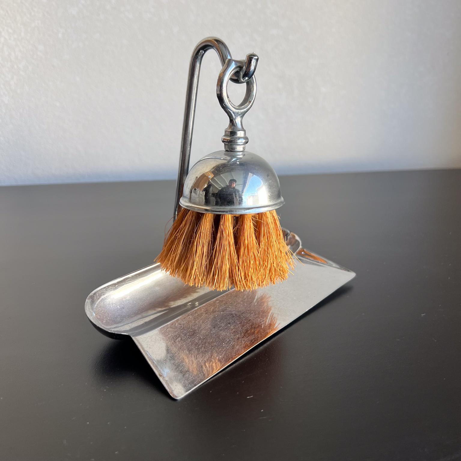 Art Deco Style Chrome Crumb Tray Valet Brush Set
Clever design, brush hangs from built in hook.
Unmarked
Original unrestored vintage condition
Light tarnishing yet possible to polish if so desired.
6.5 w x 3.5 d x 5.75 h
Refer to images.