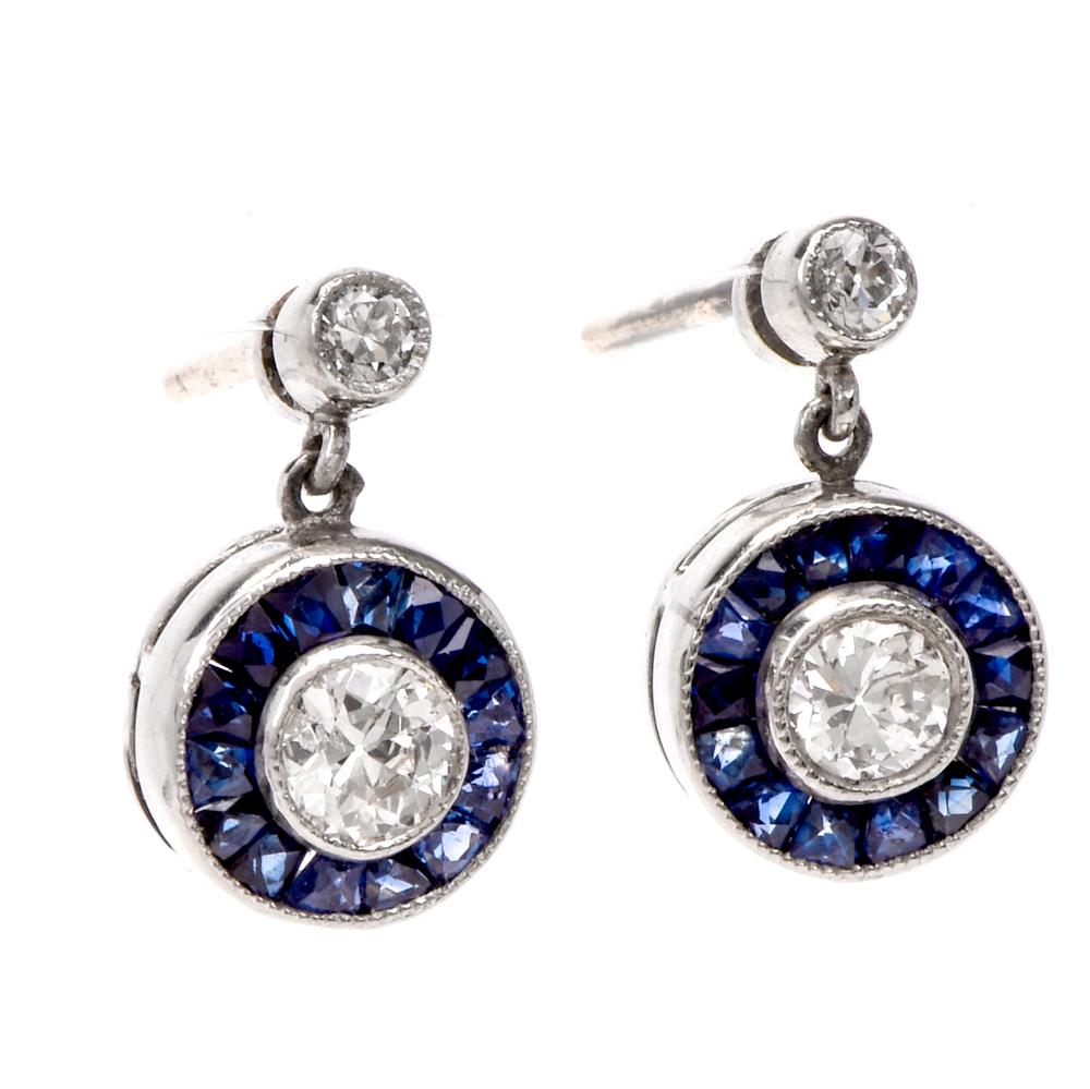 These estate art deco style circle diamond and sapphire dangle stud earrings are crafted in solid platinum. Displaying two stud round-cut diamonds and two center diamonds collectively weighing approx. 0.45cts, H-I color, SI clarity. Surrounded by a
