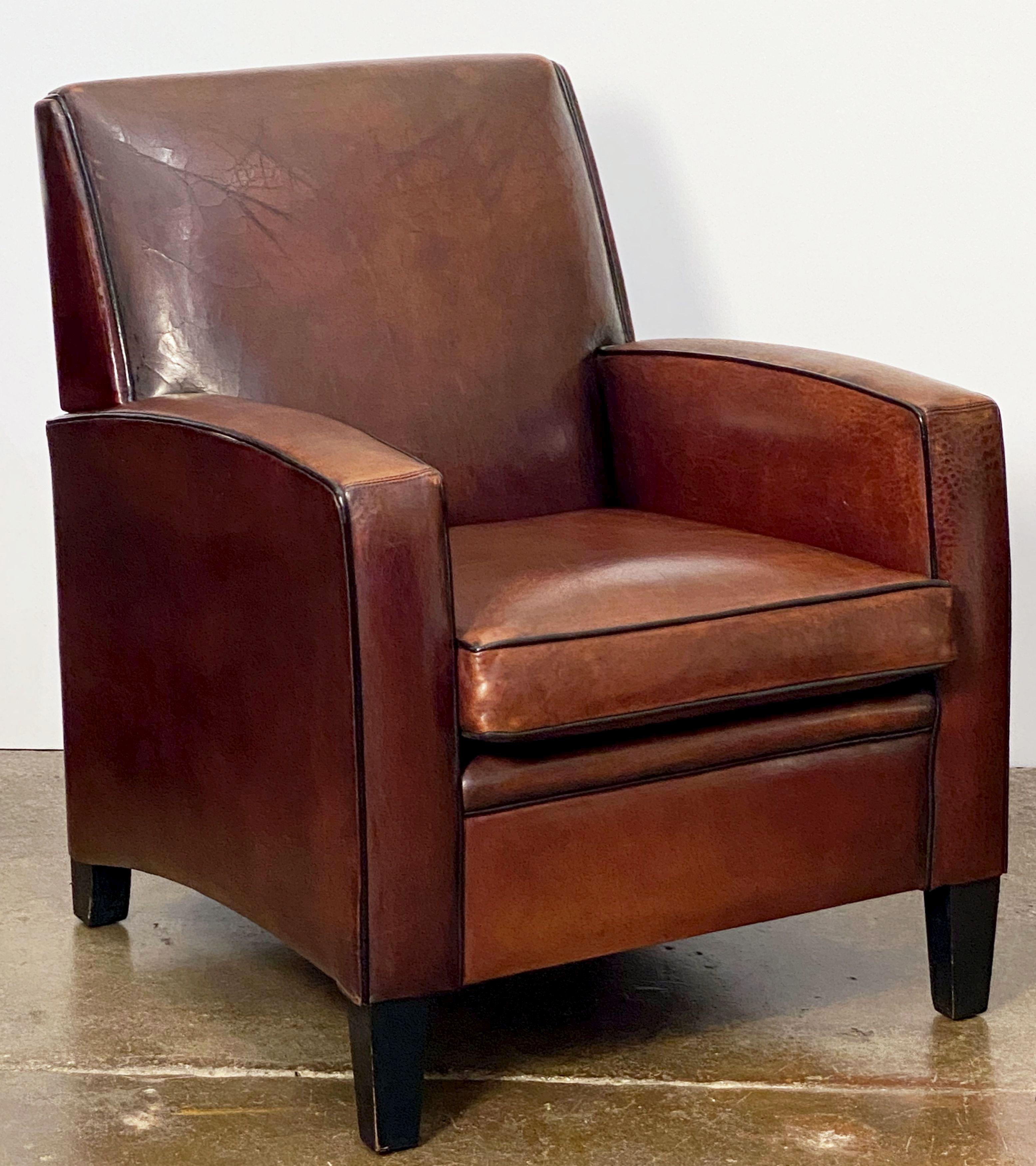 A handsome vintage Dutch leather-upholstered club or lounge chair, in the Art Deco style, featuring a comfortable back and seat with removable cushion, stylish arms, original leather, and resting on shaped feet.

Measures: Seat height is 19 inches.