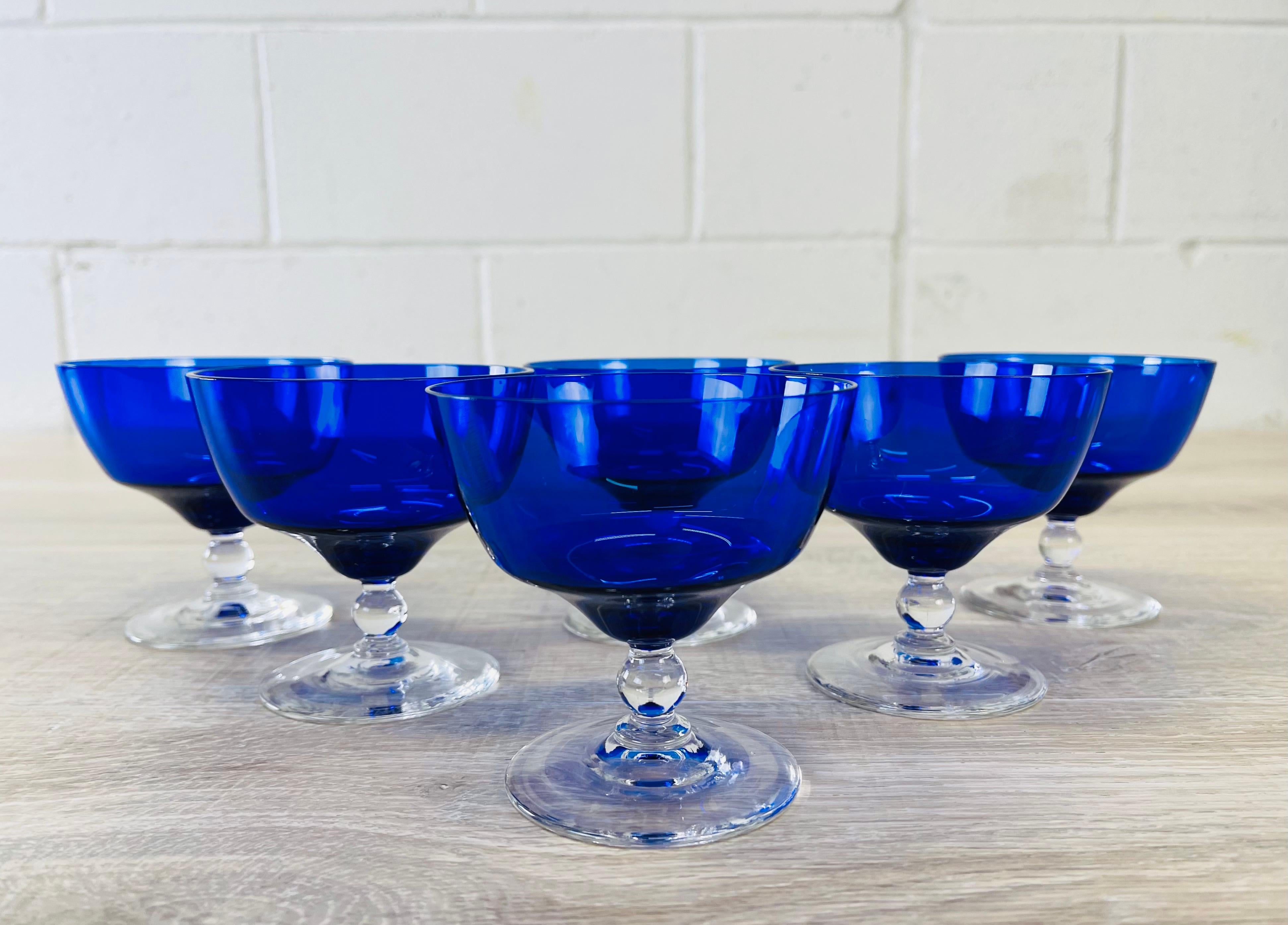 Vintage set of six Art Deco style cobalt glass low coupe stems with a clear foot. No marks.