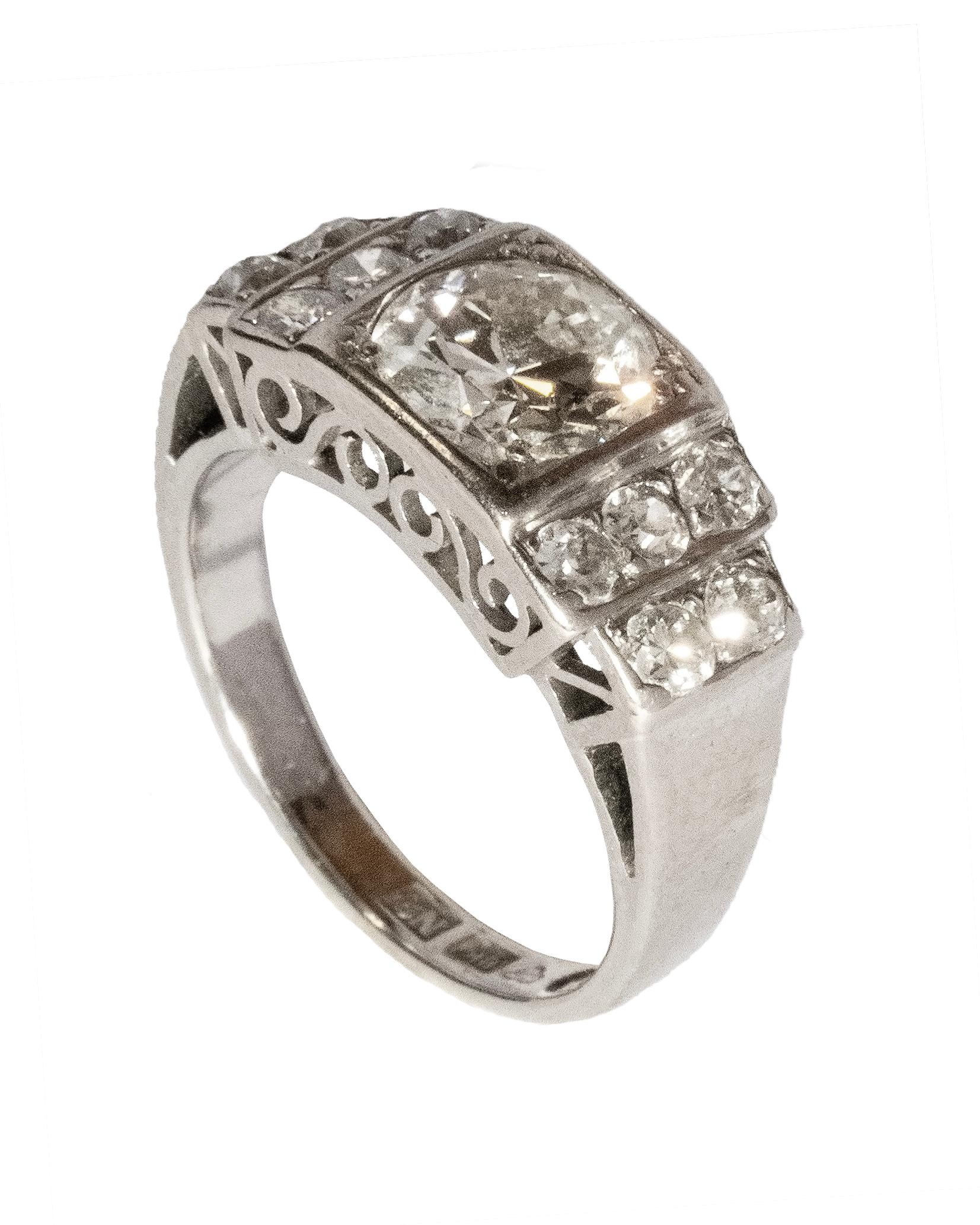 Step into the elegance of Art Deco with this Cocktail Ring, a masterpiece of vintage allure crafted in Sweden in the 1960's. This ring, fashioned from 18k white gold, seamlessly blends the glamour of the Art Deco era with the chic sophistication of