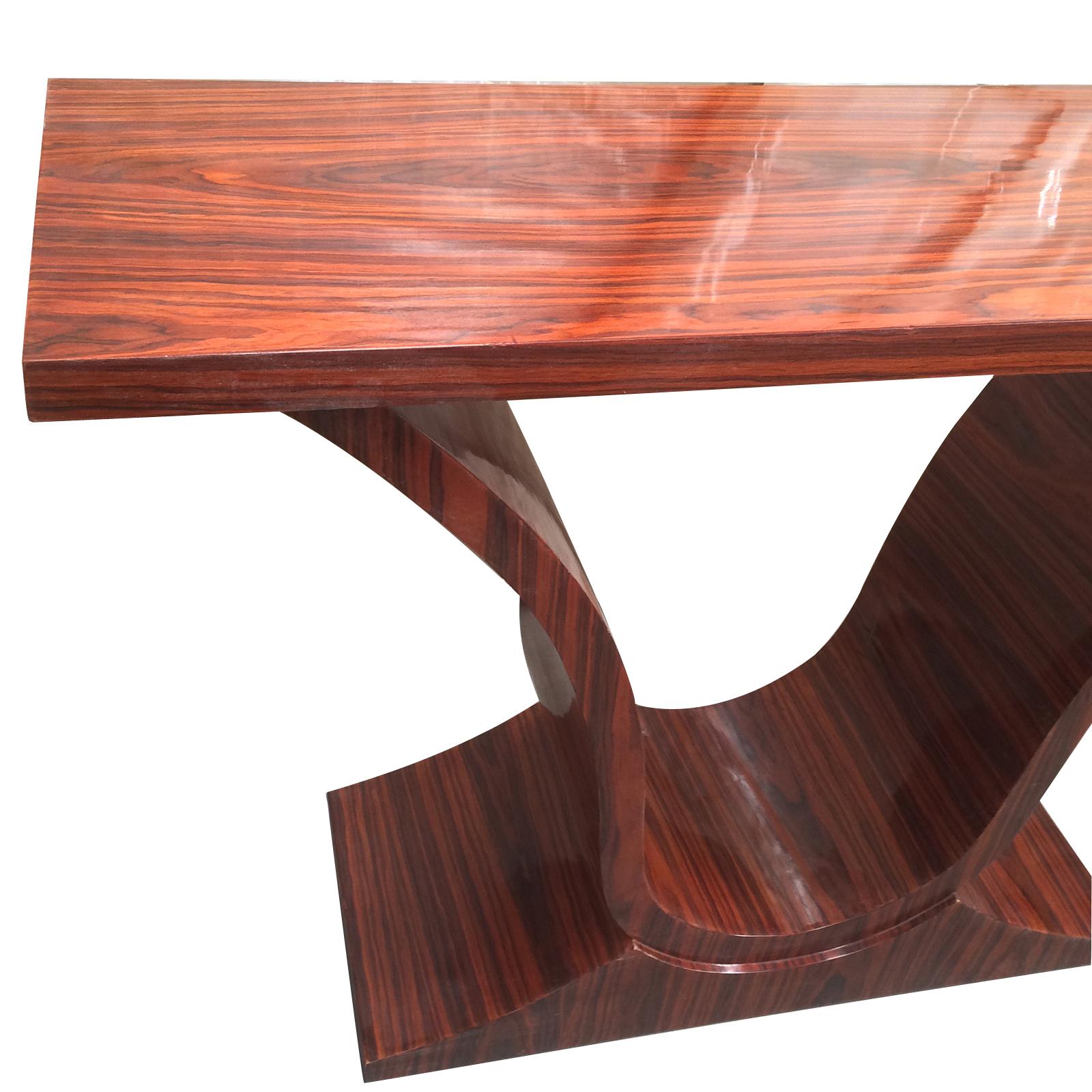 Ultra, Art Deco style console table in an Iconic shape, in Amboyna wood in glazed finish, all in excellent condition. Decorative contrast in timber, with Pillow cut, broad grain inverted “U” over centre of lower area of the curved legs. Splayed feet