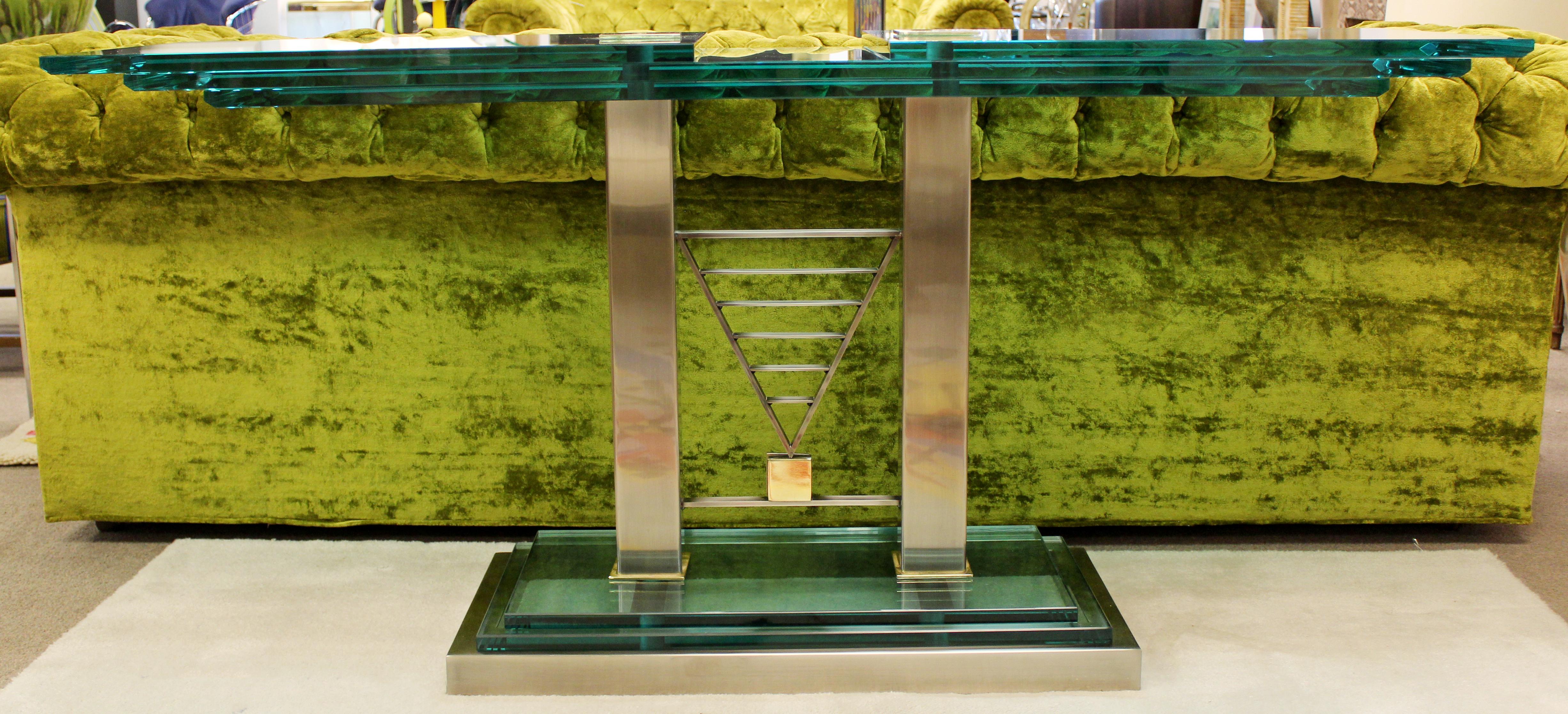 For your consideration is a magnificent DIA, Design Institiute of America, Art Deco style console table, made of glass, brass and chrome steel, circa 1990s, excellent condition. The dimensions are 59.5