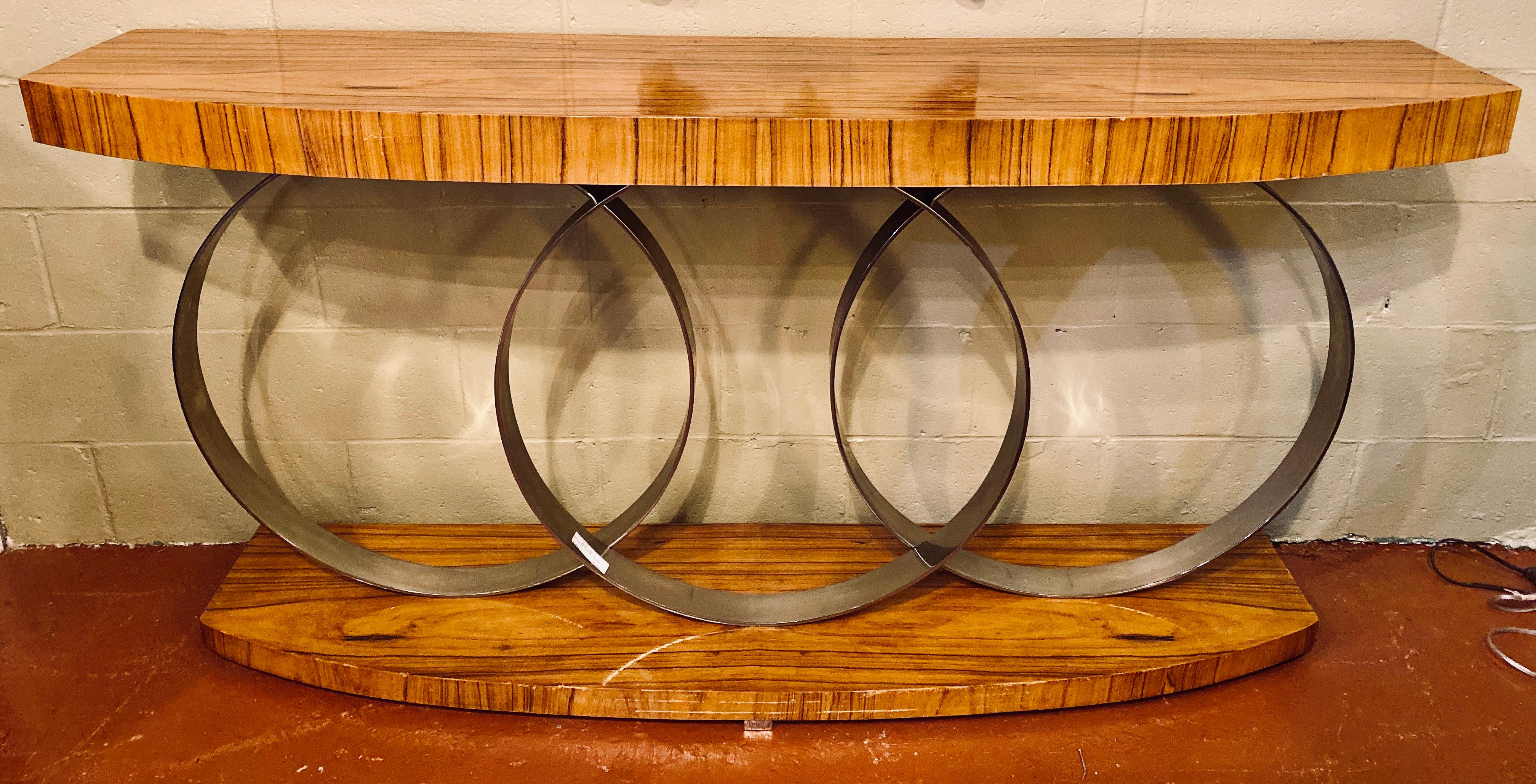 An intriguing console table in the Art Deco taste, Mid-Century Modern, the top and bottom plinths are supported and separated by three chrome loops. Very heavy.