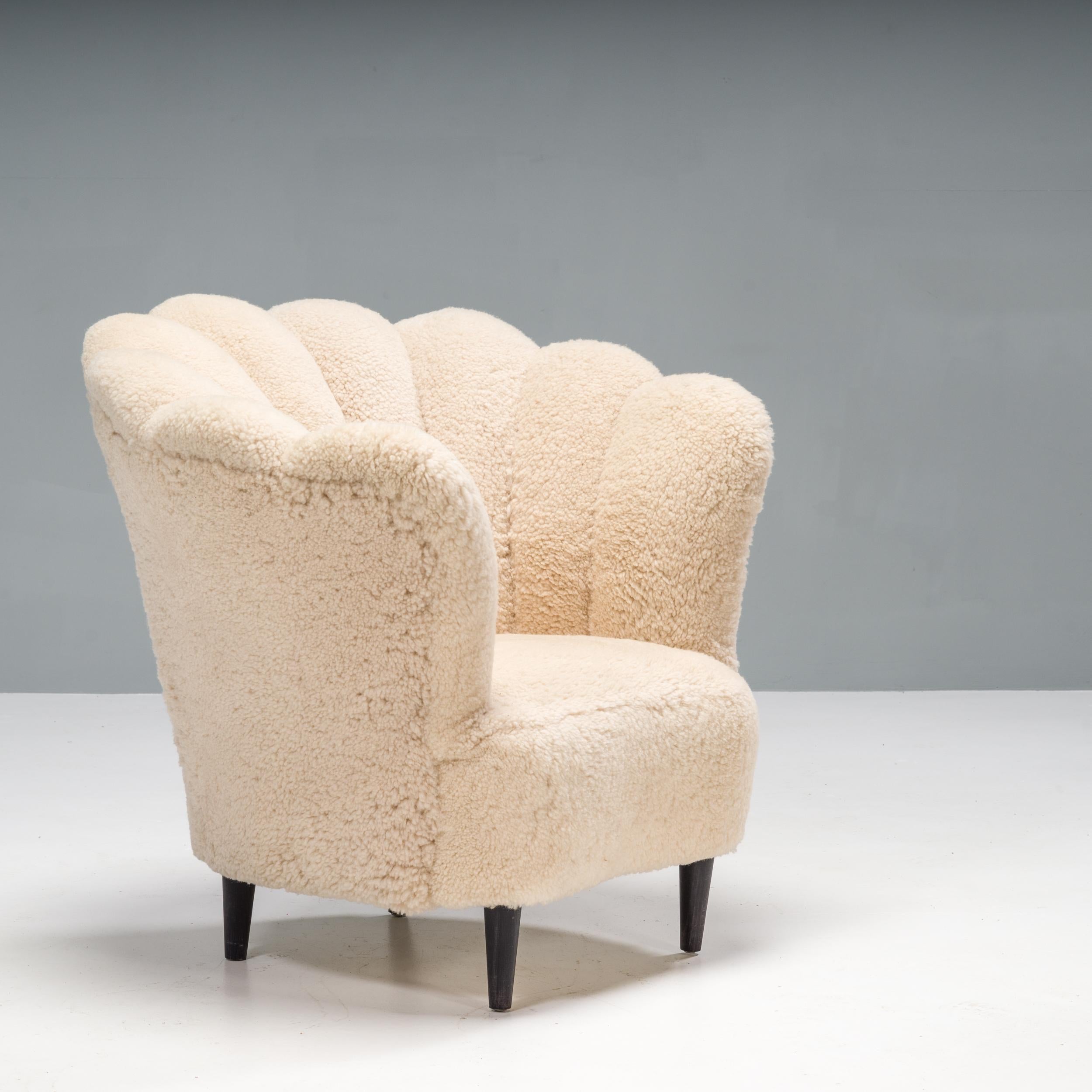 A beautiful vintage tub Danish Art Deco armchair in the manner of architect Flemming Lassen. This armchair features a scalloped backrest, which curves around the sides of the chair, enveloping and comfortable.

Fully recently upholstered in
