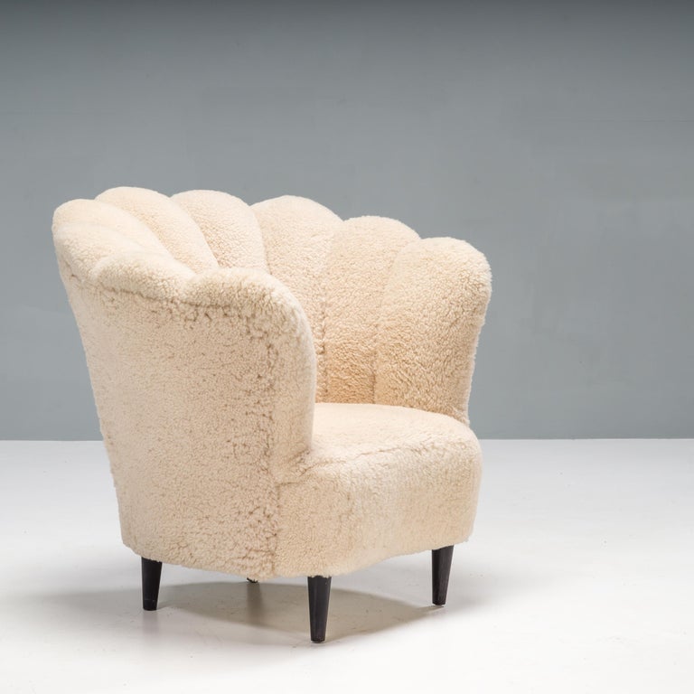 A beautiful vintage tub Danish Art Deco armchair in the manner of architect Flemming Lassen. This armchair features a scalloped backrest, which curves around the sides of the chair, enveloping and comfortable.

Fully recently upholstered in