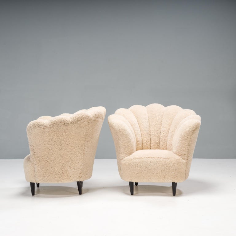A beautiful pair of vintage tub Danish Art Deco armchairs, in the manner of architect Flemming Lassen. These armchairs feature a scalloped backrest which curves around the sides of the chair, enveloping and comfortable.

Fully recently upholstered