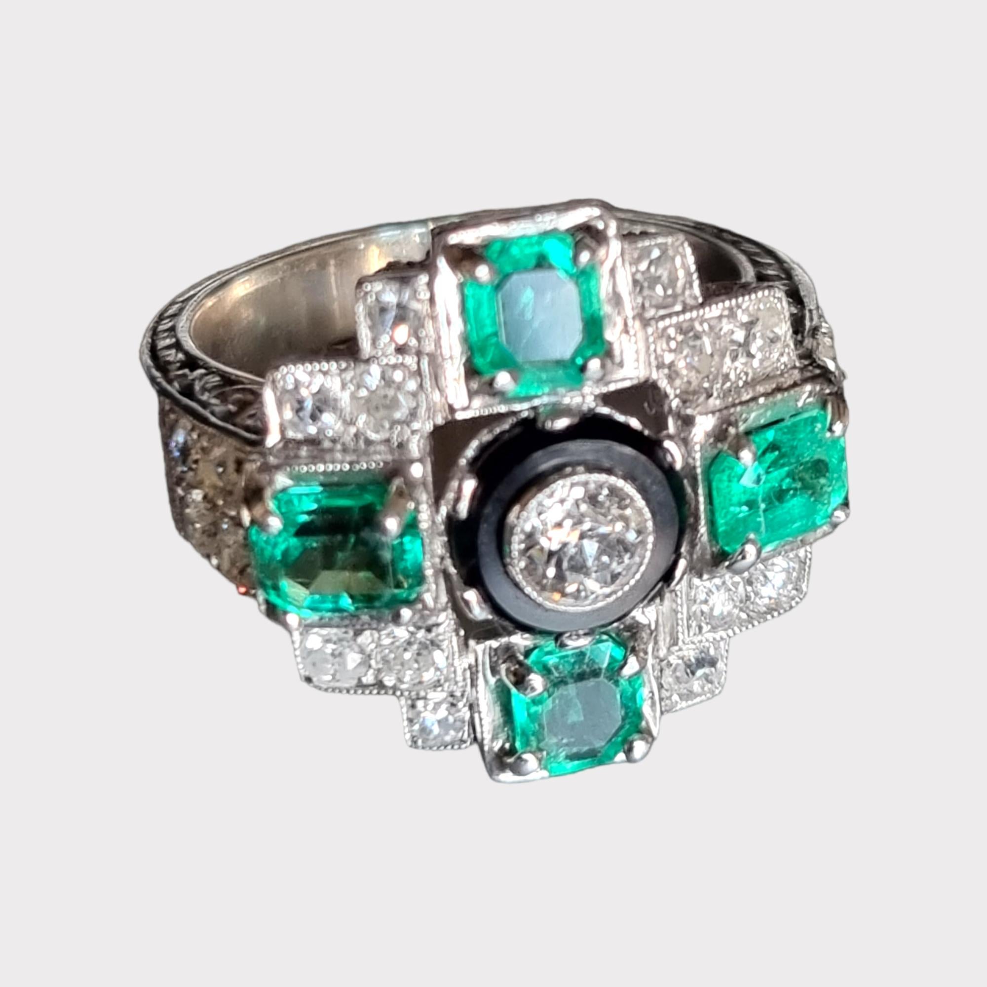 Art-Deco Style Cross Shaped  Design Emerald, Diamond  and Onyx Cocktail Ring.
This stunning cocktail ring shines with an undeniable opulence mounted in 950 platinum. The pierce decorated  as a cross shaped cluster design is embellished with an