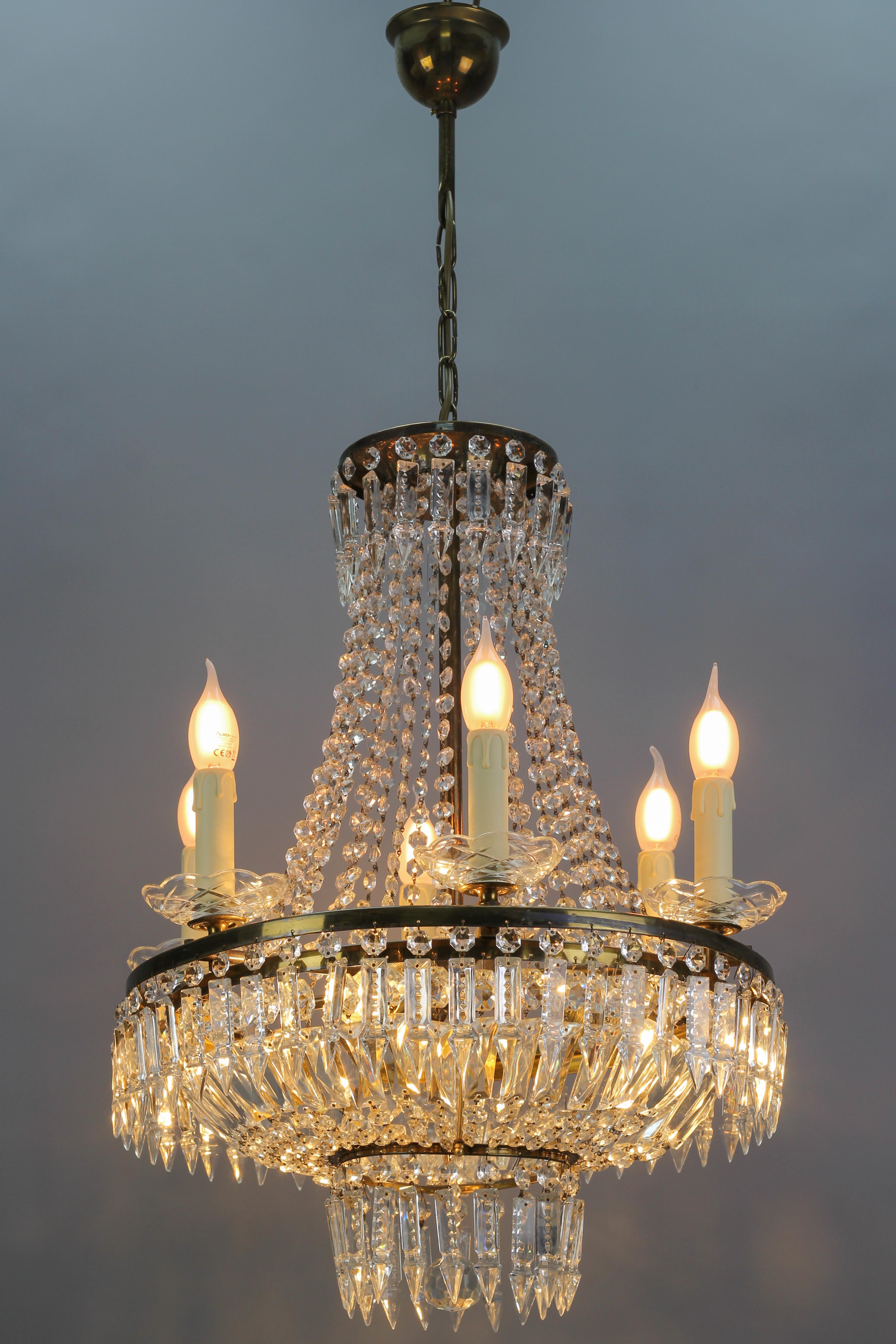 French Art Deco style crystal glass basket-shaped chandelier features six external and three internal lights. This beautiful piece has a brass frame hung with chains of crystal glass beads and prisms forming a basket shape and reflecting the light