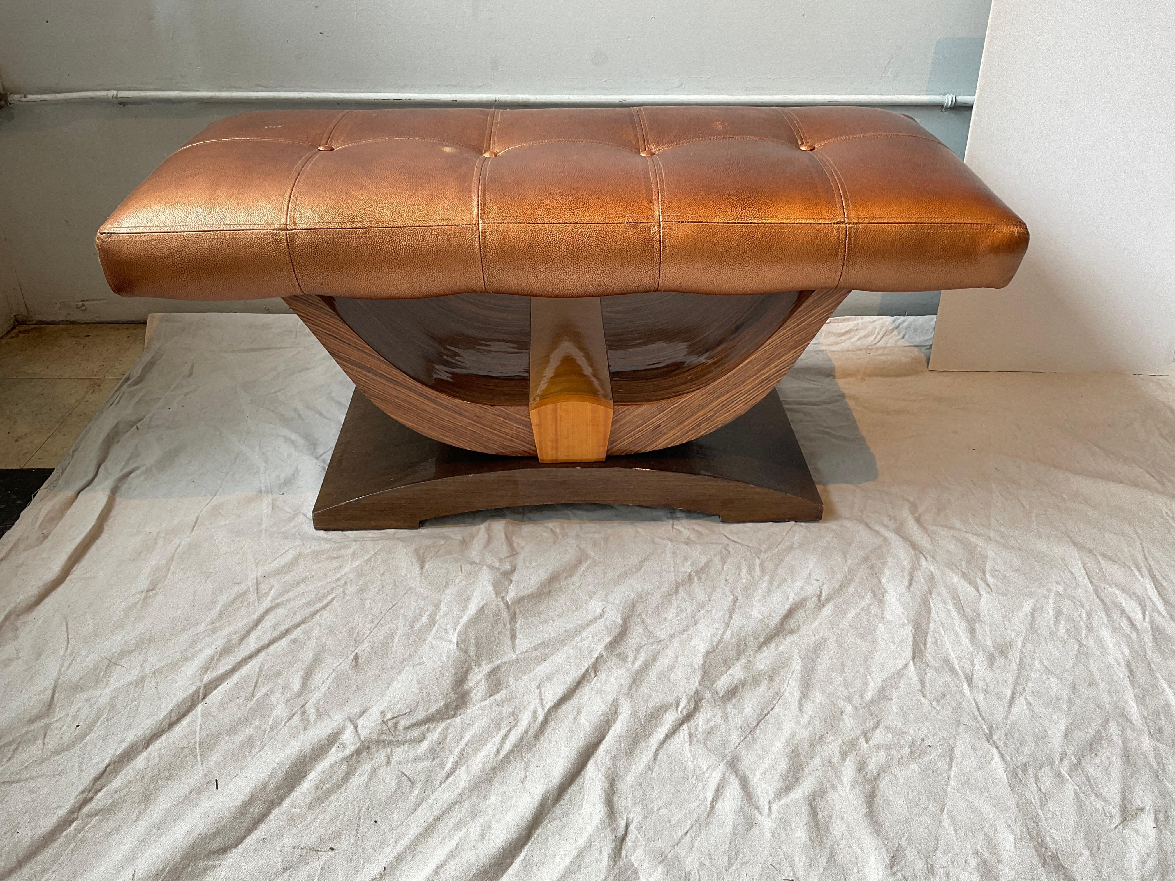 Custom made art deco style bench circa 2000.  Exotic woods, leather seat. Original cost was $4800. 
Knicks in finish. Seat has a few stains.