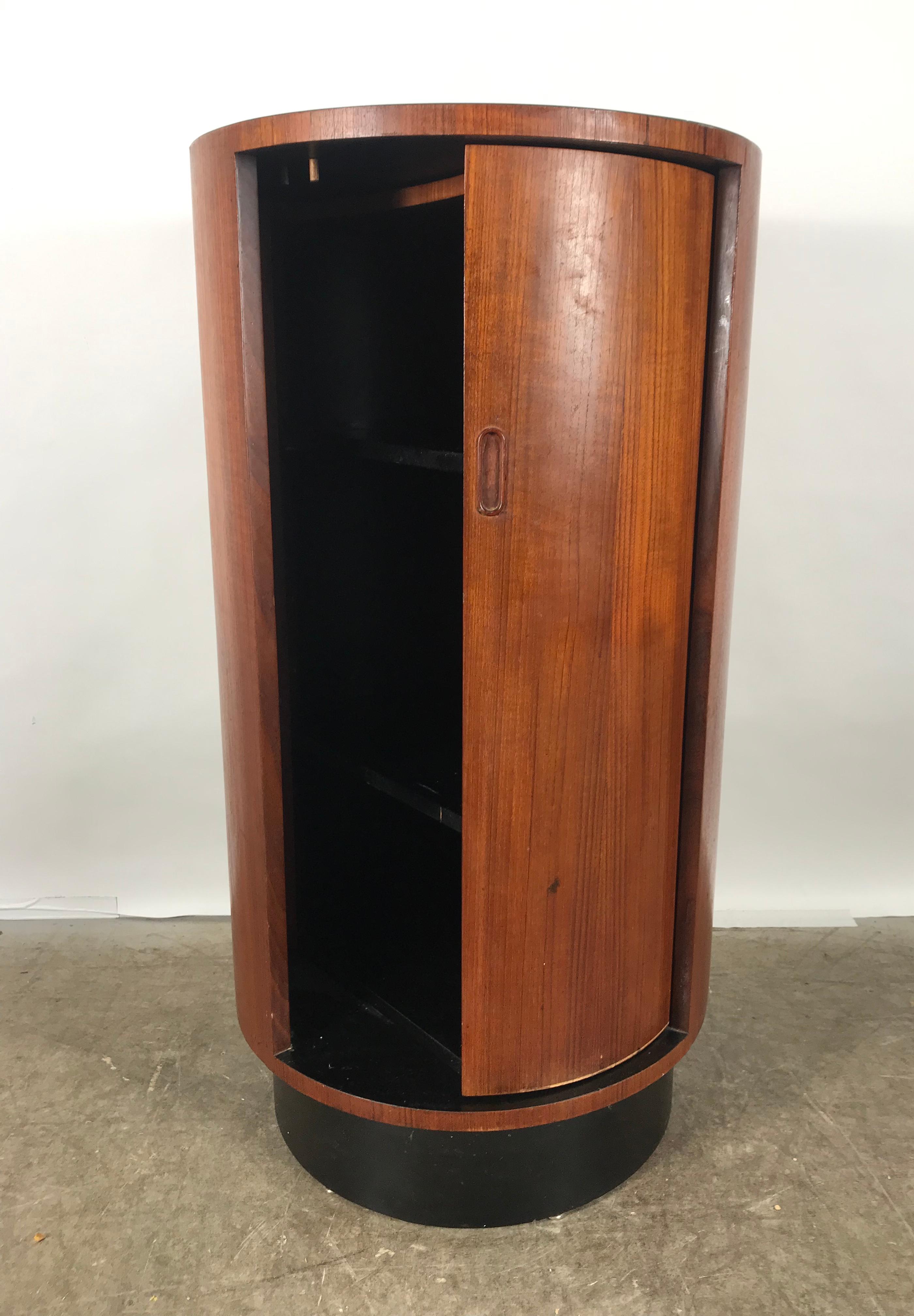 Art Deco style cylinder bar, Lazy Susan revolving shelf interior. Made by R S Assocciates, Classic design, original finish and patina, black laminate top. Hand delivery avail to New York City or anywhere en route from Buffalo NY.