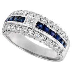 Anello a mezza eternità con diamante e zaffiro blu in stile Art Déco in oro bianco 18 carati