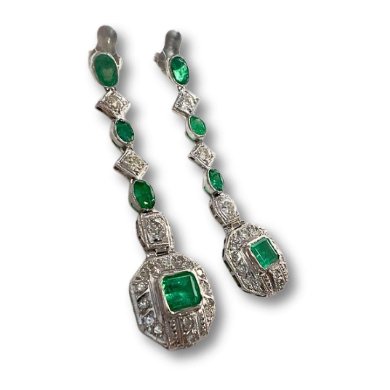 Discover timeless elegance with these Art Deco style earrings crafted in 750 karat platinum, adorned with diamonds and emeralds. Weighing 14.60 grams, these earrings boast a length of 6.5 cm, making them a striking statement piece for any