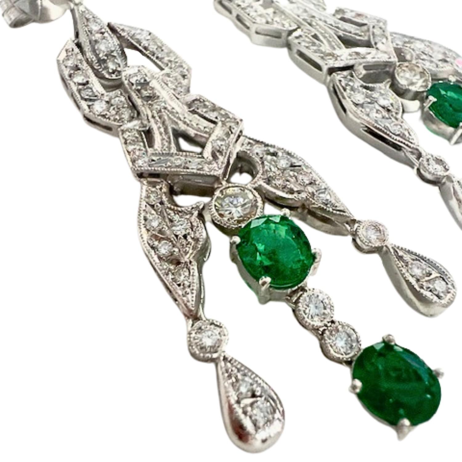 These earrings showcase an Art Deco design, crafted in platinum 950 and adorned with brilliant-cut Diamonds and an oval-cut Emerald. 

The Diamonds total 2.24 carats and are of SI clarity and H-I color grade. 

The Emerald is 2.47 carats and is
