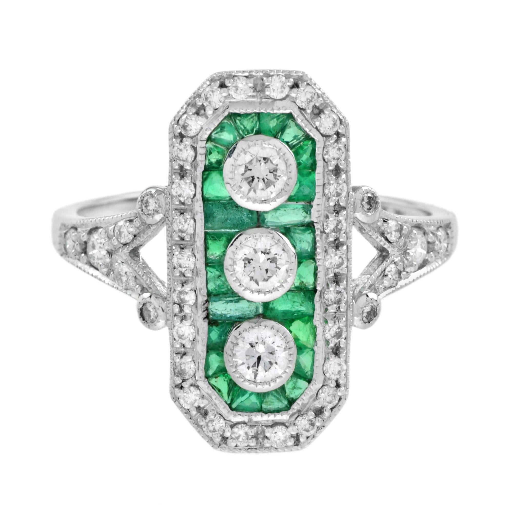 A seamless vertical flash of sparkle is created by three round cut central diamonds – in this superlative and utterly impressive Art Deco style dinner ring. The scintillating trio are outline by emerald and diamond octagonal frame which leads to