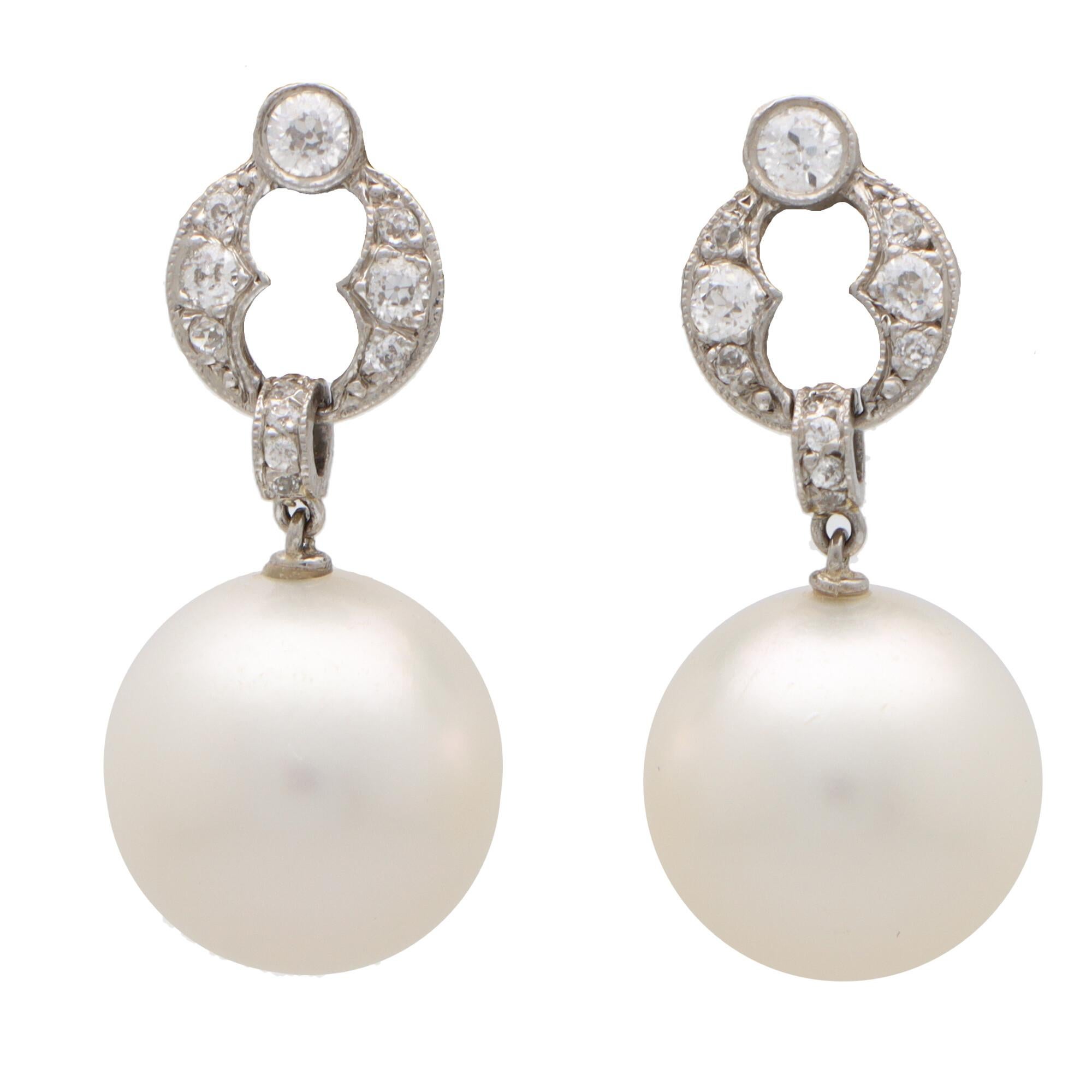 Round Cut Art Deco Style Diamond and Pearl Drop Earrings Set in Platinum For Sale