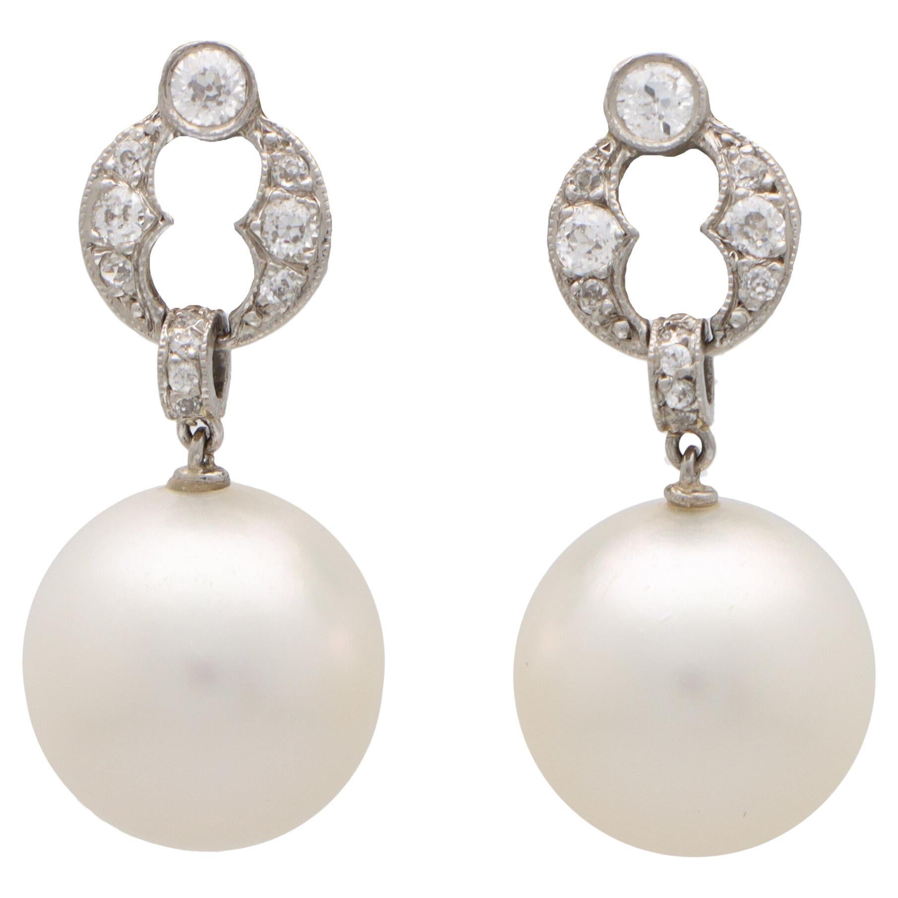 Art Deco Style Diamond and Pearl Drop Earrings Set in Platinum For Sale
