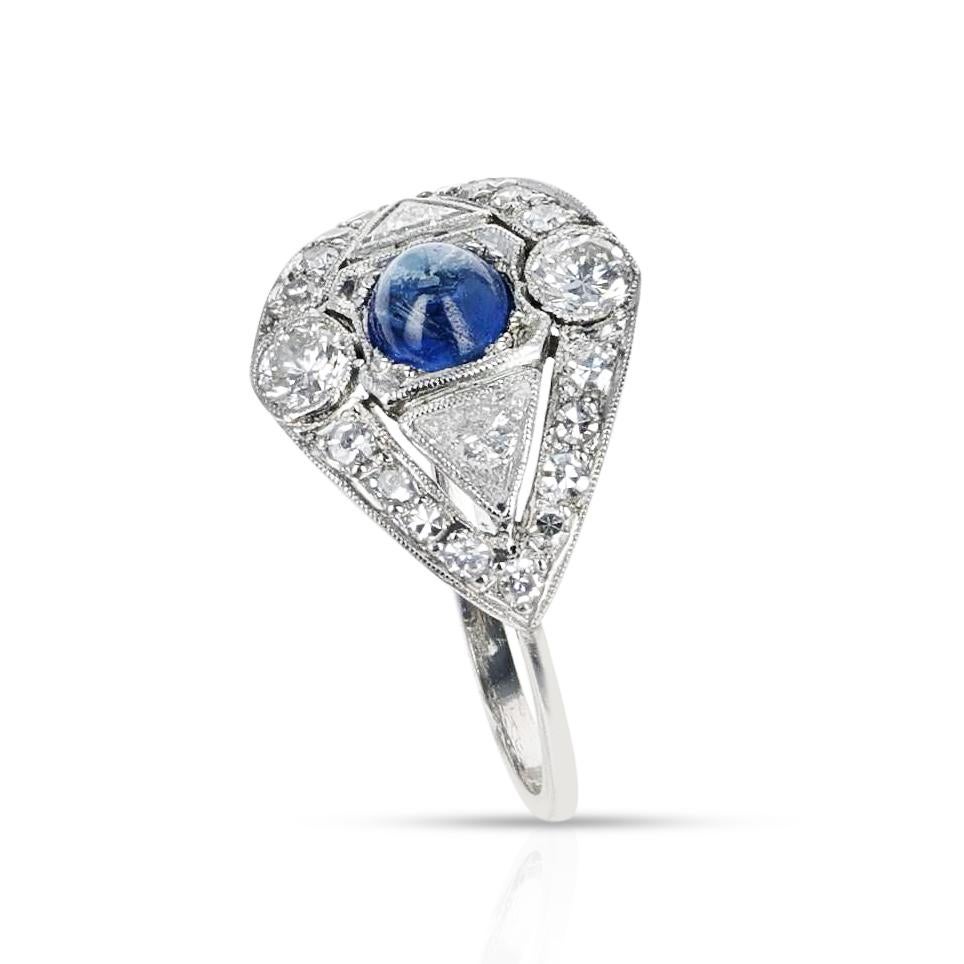 An Art Deco-Style Diamond and Sapphire Cabochon Platinum Ring. The appx. weight of the diamonds is 1.20 carats and the sapphire weighs appx. 0.50 carats. The total weight of the ring is 3.74 grams. The ring size is US 7.50. 