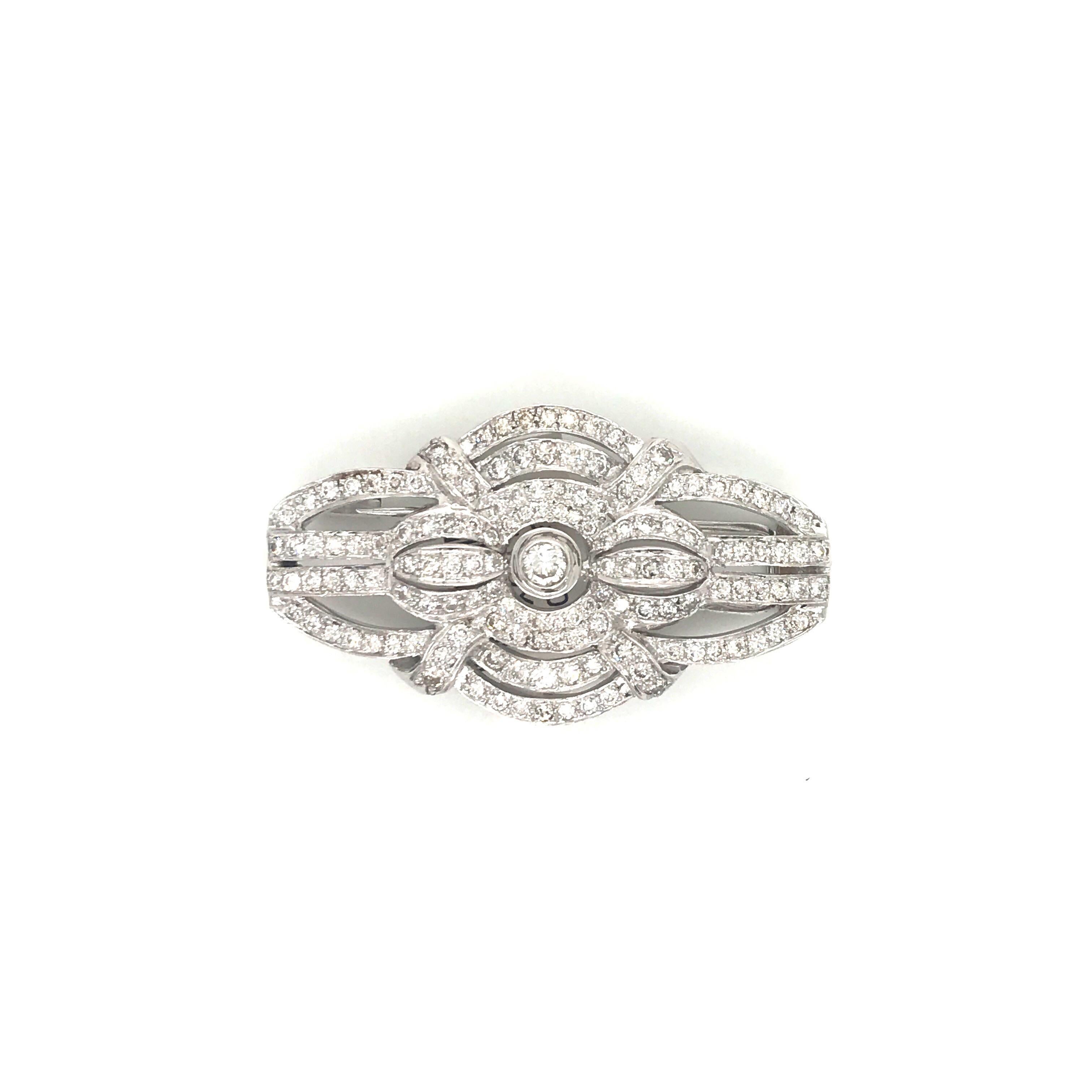 Stamped Italy 18K, this Art Deco inspired brooch features numerous round brilliants weighing 2.50 carats.
Color H
Clarity SI