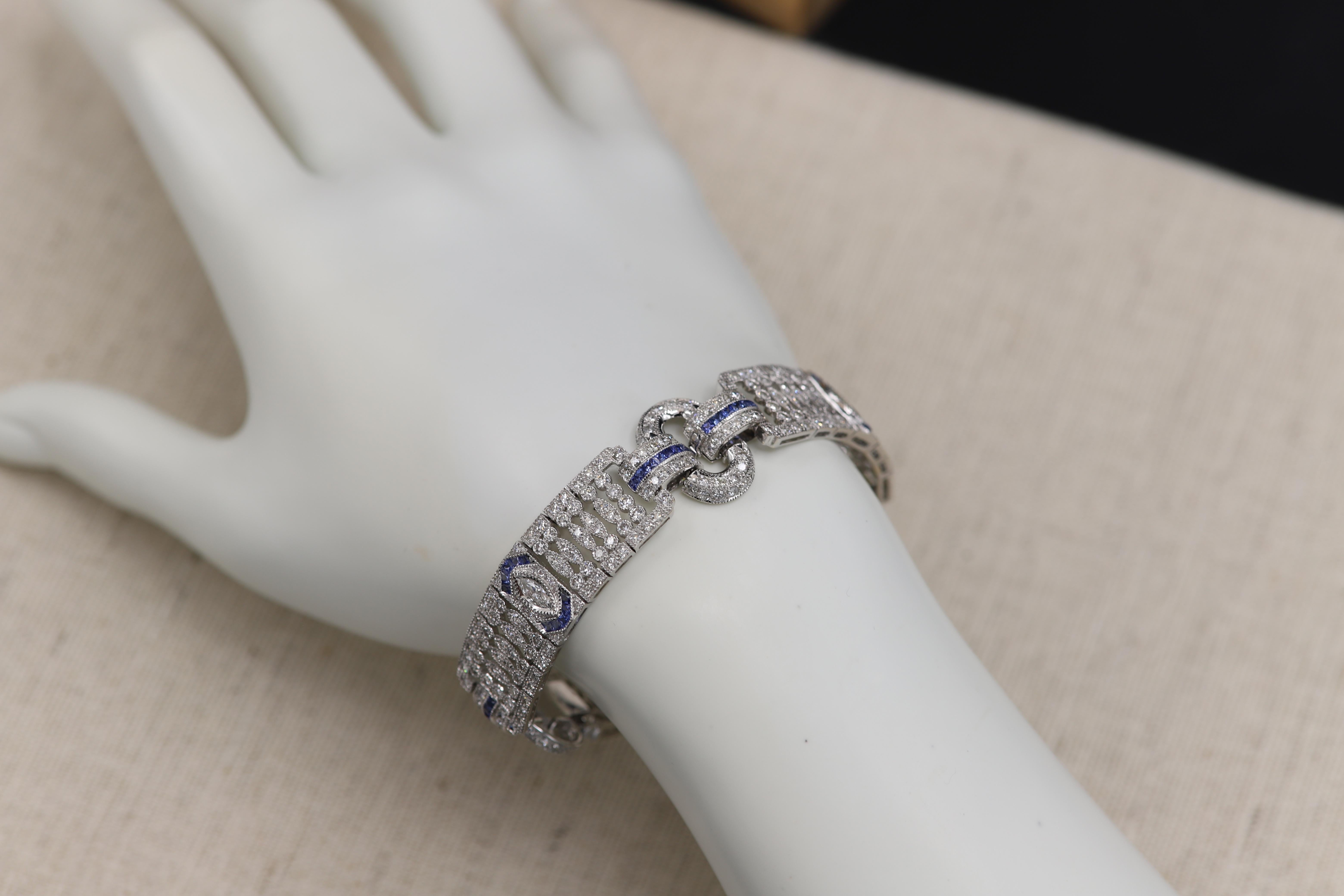 Art Deco Style, 
Impressive Statement Bold Bracelet.
Diamonds & Blue Sapphire - All Natural.
Total Diamonds 7.24 carat G-VS-SI
Total Blue Sapphire 2.71 carat.
18k White Gold 34 grams
Bracelet Width 13 mm