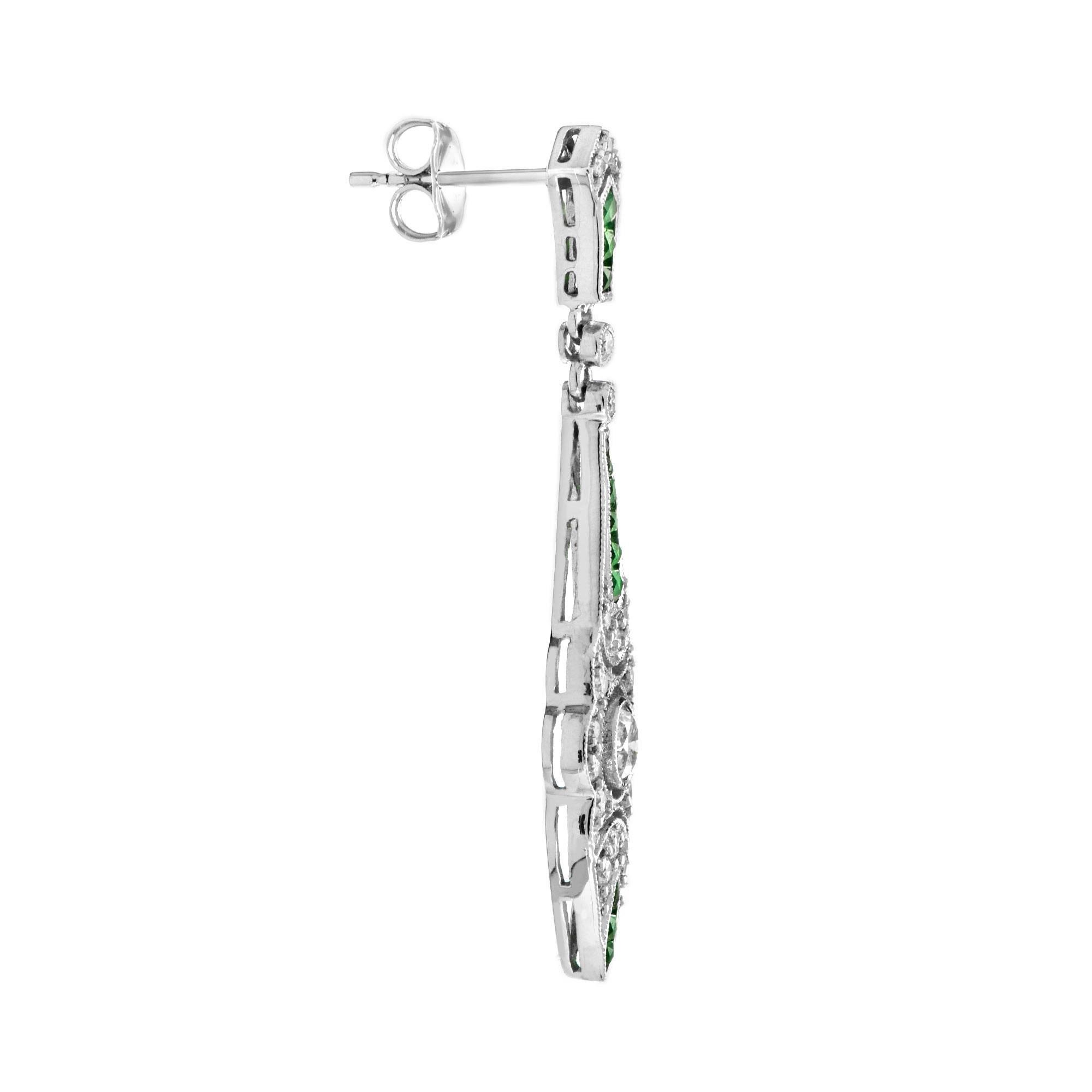 These eye-catching Art Deco style earrings are hand crafted with an intricately detailed geometric design. At the center of each earring, a round diamond is set together with shimmering diamond accent. These settings are elegantly hanging from