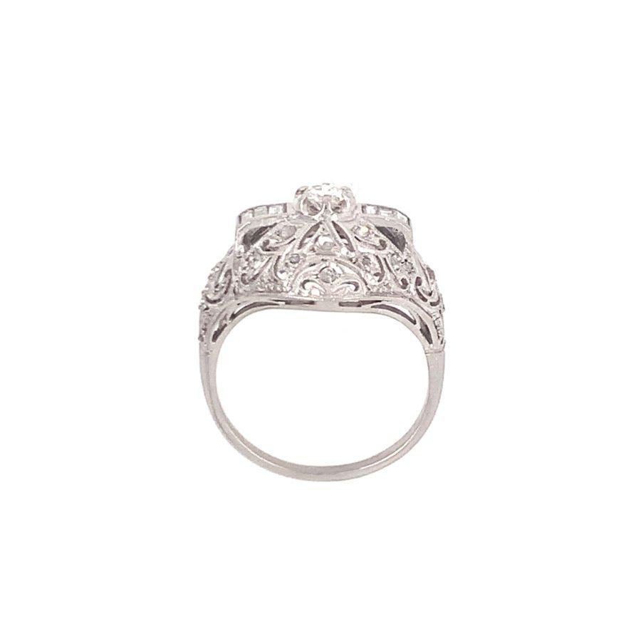 One art deco style diamond filigree platinum ring featuring 31 round, straight baguette and rose cut diamonds totaling approximately 0.50 ct. with H-I color and VS-2 clarity. Pierce motif, dome design reproduction typical from the 1920s jewelry