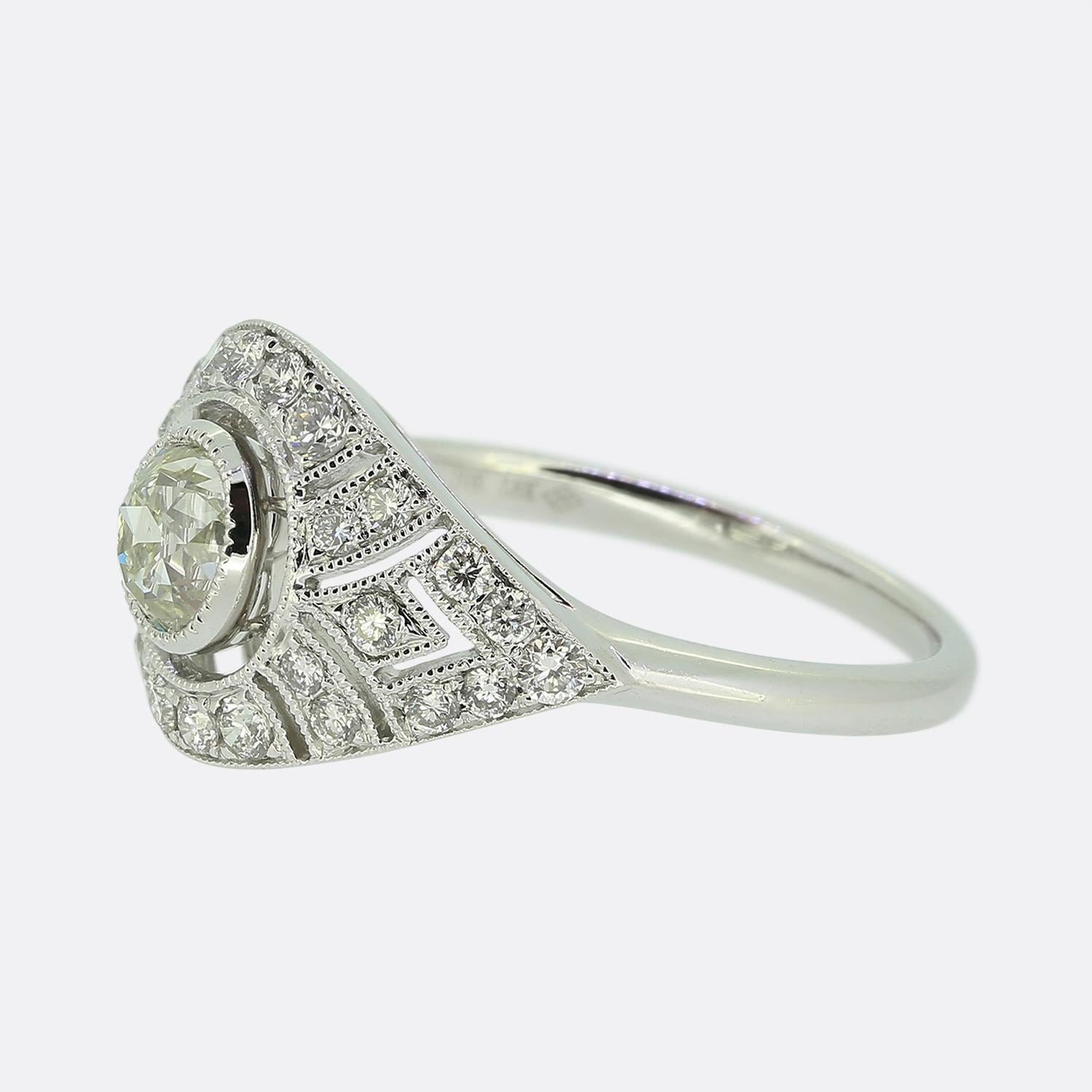 Here we have an Art Deco style 18ct white gold diamond ring excellently paying homage to the elegance of the period. The ring features an impressive lone milgrain set old cut diamond at the centre. However, the piece really comes to life via its