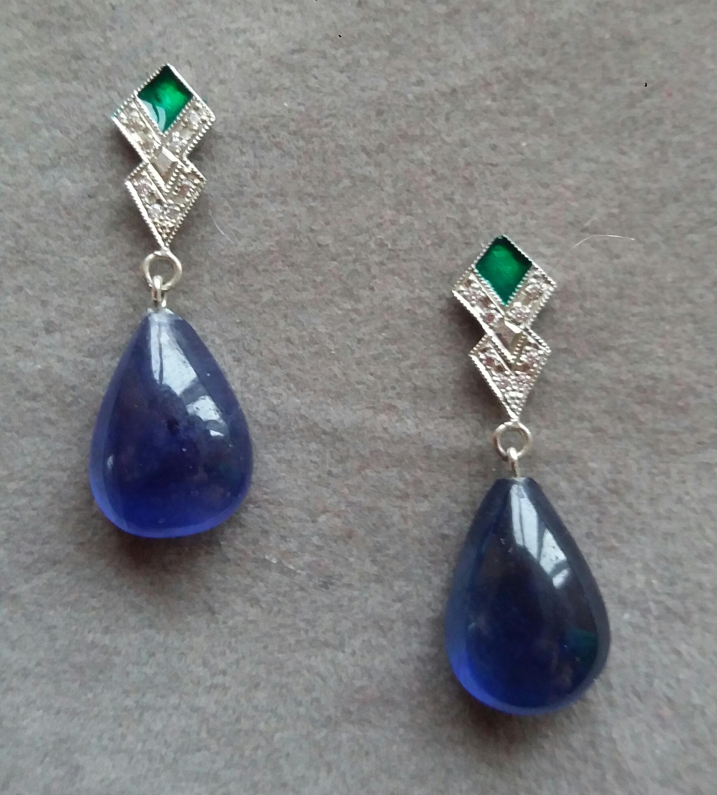 In these classic Art Deco Style earrings the tops are 2 elements  in 14 kt. white gold, 16 round full cut diamonds and Green Enamel,,in the lower parts we have 2 big size Pear Shape Blue Sapphire Cabs  measuring 11 x 15 mm and weighing 22 carats

In