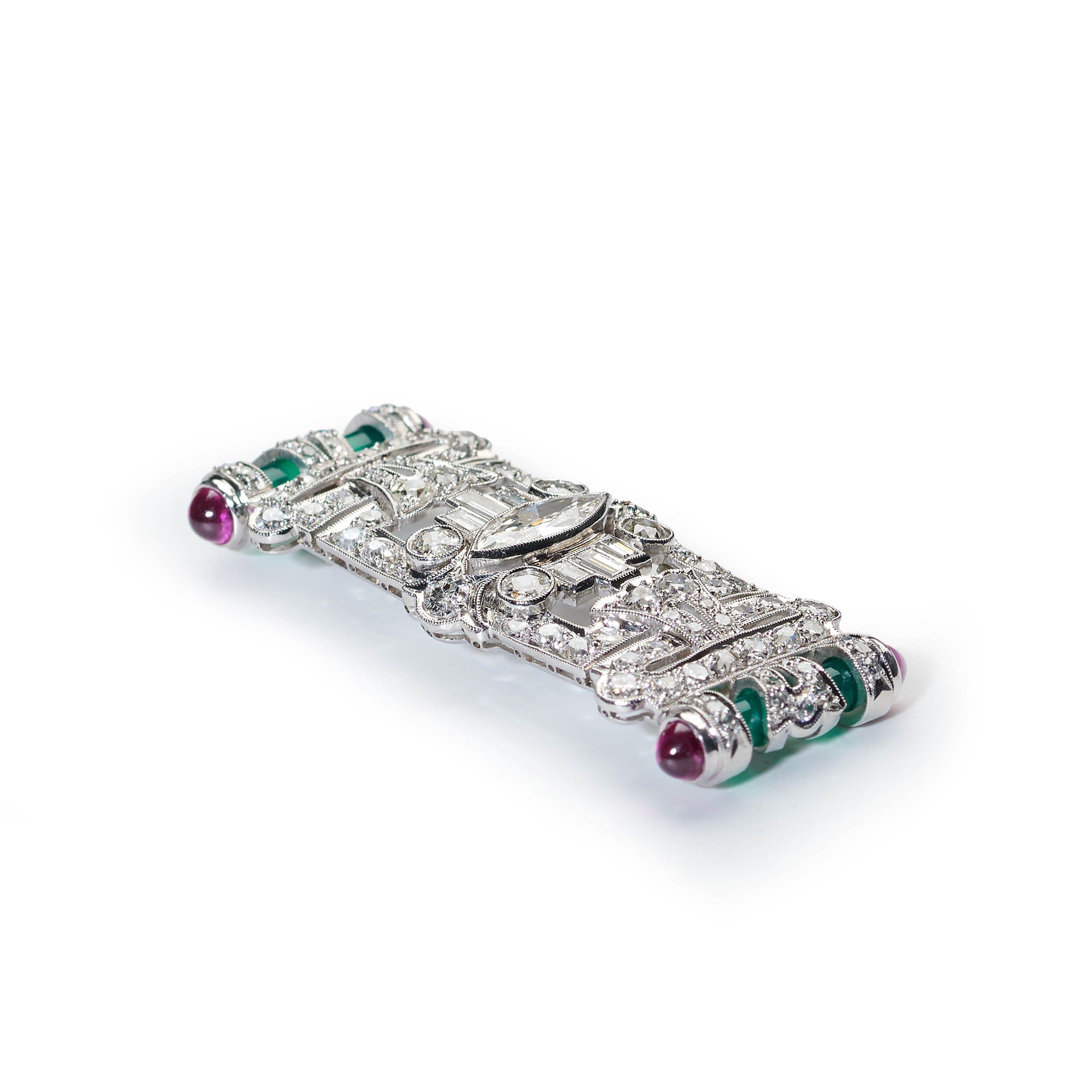 An Art Deco style diamond, green agate and ruby brooch, set with a central marquise diamond, with three baguette-cut diamonds either side, in rub over settings  and trefoils of old-cut diamonds above and below, onto a rectangle of old-cut, eight-cut