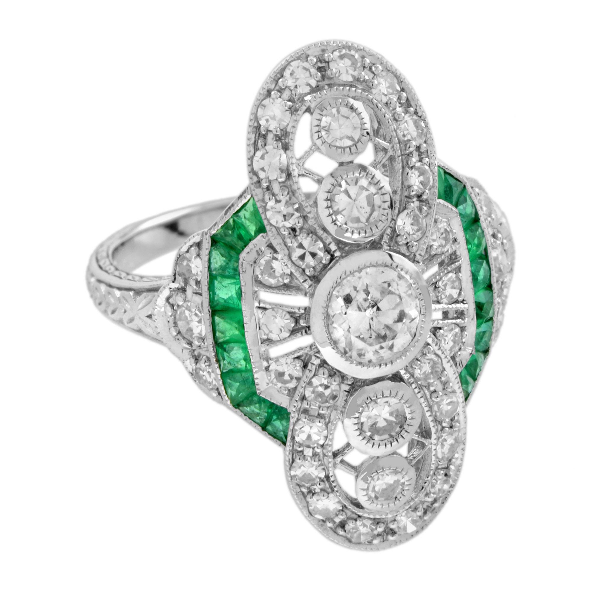 This Art Deco style ring sits low and hugs the finger nicely. It features round old cut diamonds in the center with French cut emerald on its west and east. Then multiple round cut diamond surround it. The millgrain adds to the vintage style. 14K