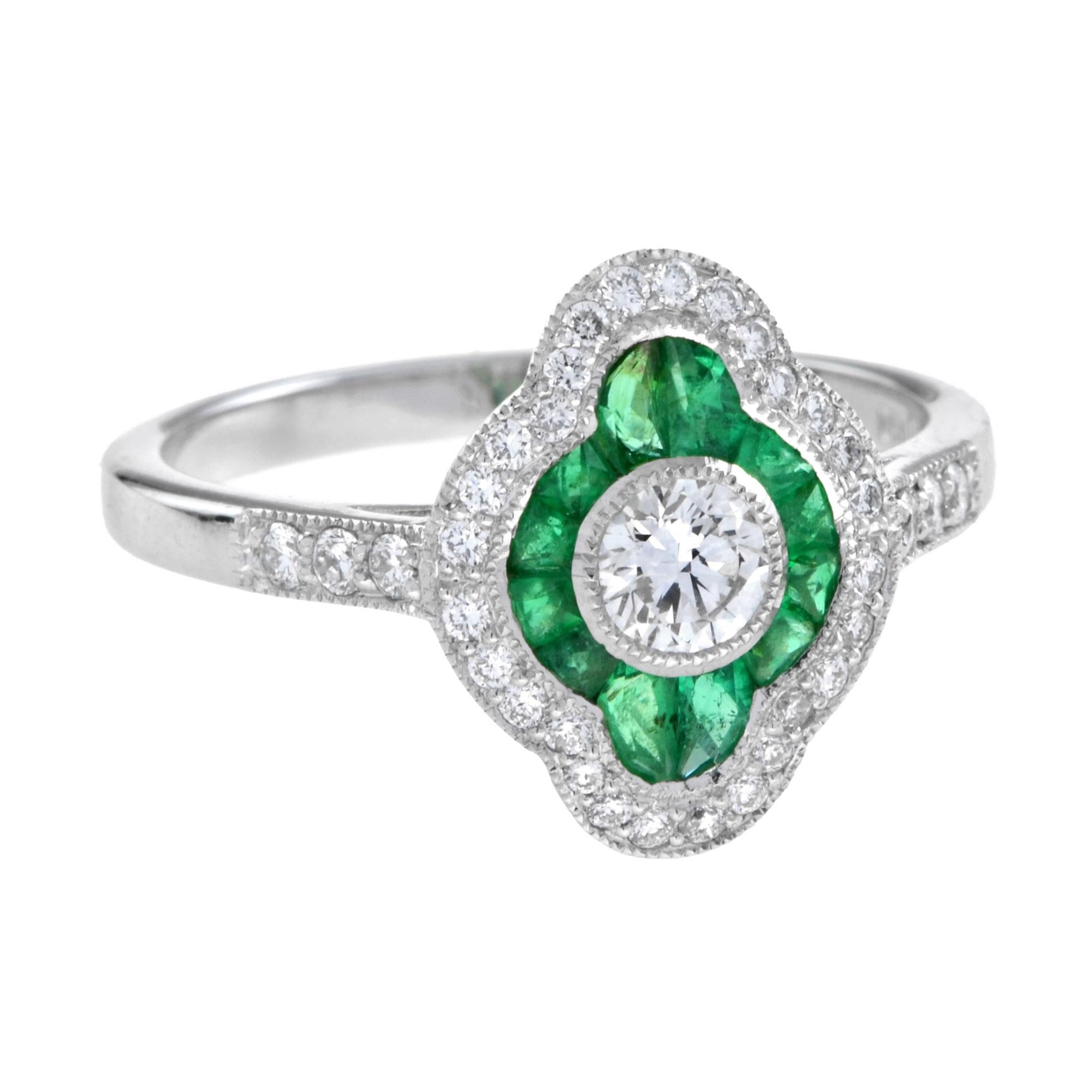This lovely target ring boasts a center diamond weighing 0.26 carat. The center diamond is encircled by French cut emeralds. In addition to the emerald halo, the ring offers a halo of round diamond on the outer rim the perfect way to round off the