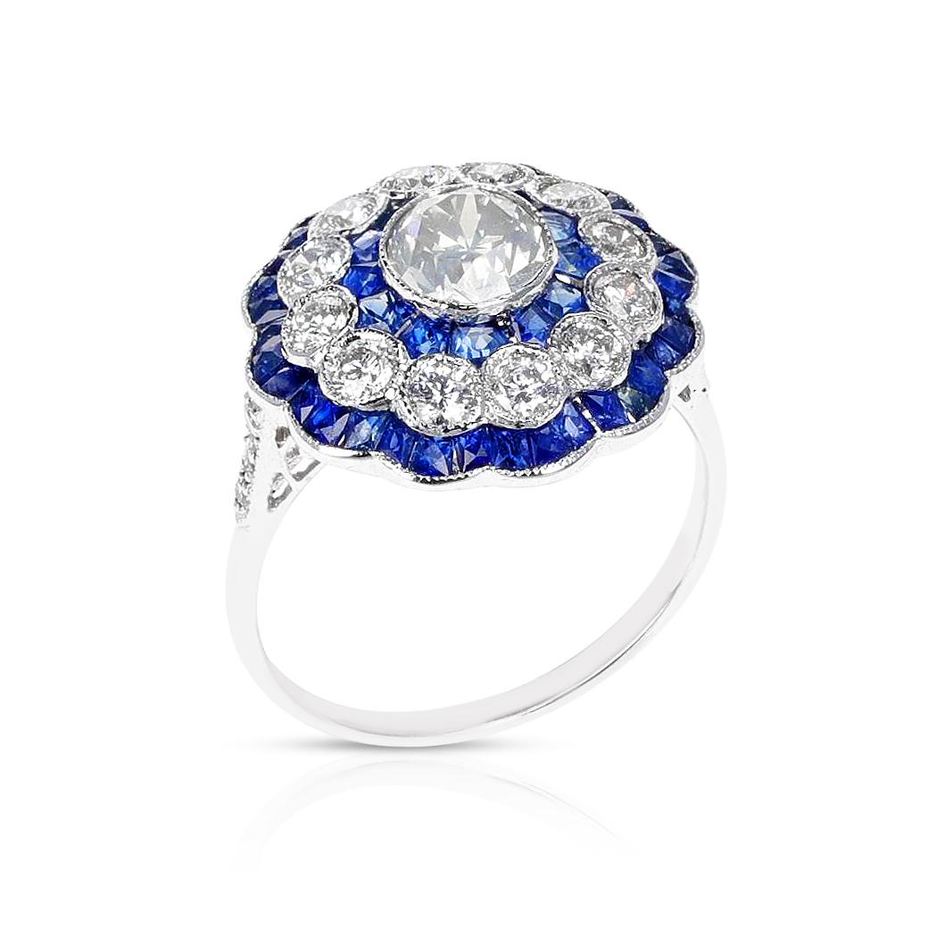 An Art Deco Style Diamond Old European-Cut and Sapphire Ring. Matching Earrings available.  Ring Size US 7. Made in 18K White Gold. The center stone is appx. 0.55 carats. 