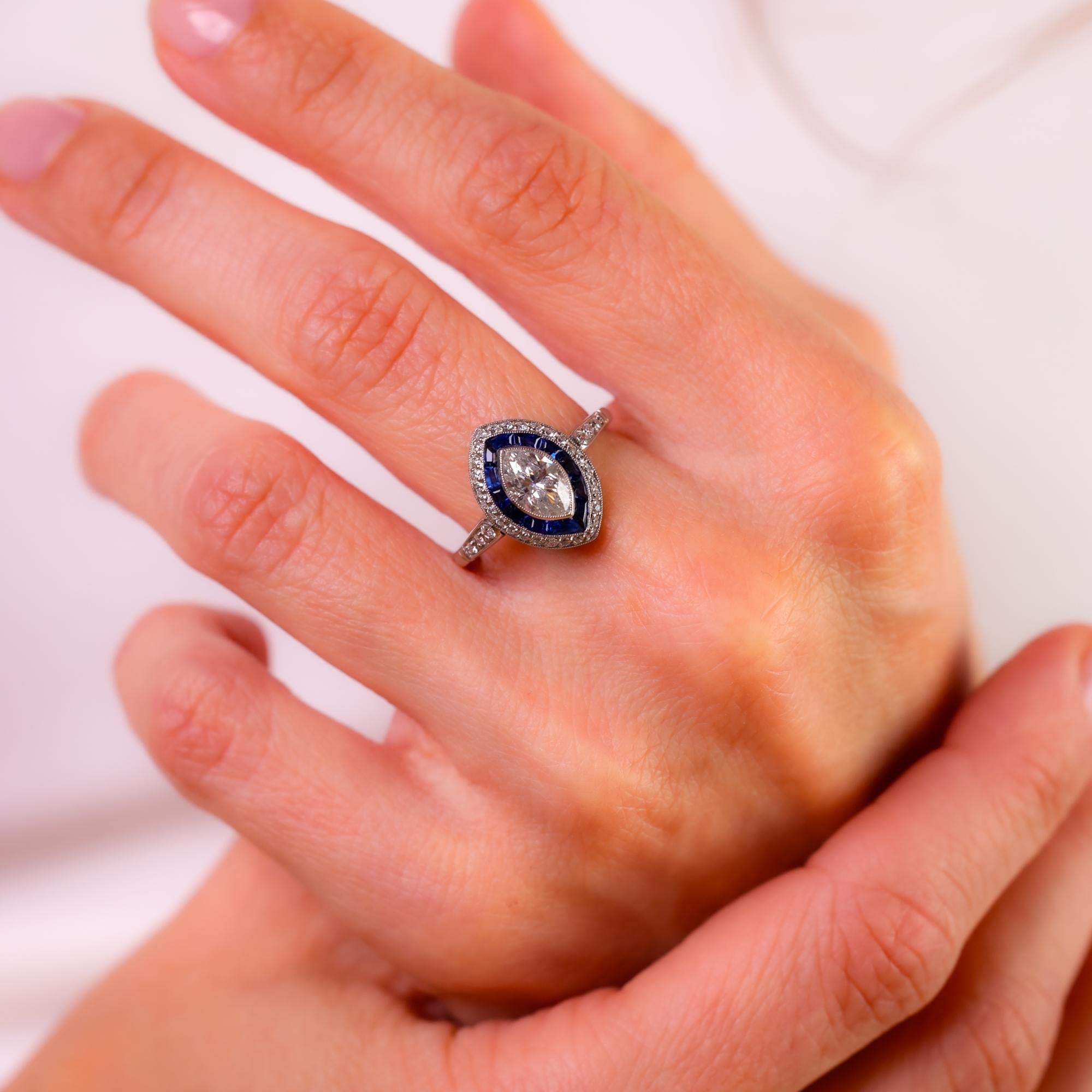 This Art Deco-style platinum ring from the 1990s showcases a striking marquise cut diamond, framed by deep blue sapphires and sparkling diamonds for a vintage-inspired elegance.

Center stone: Marquise cut diamond
Weight: 0.78 carats
Color: