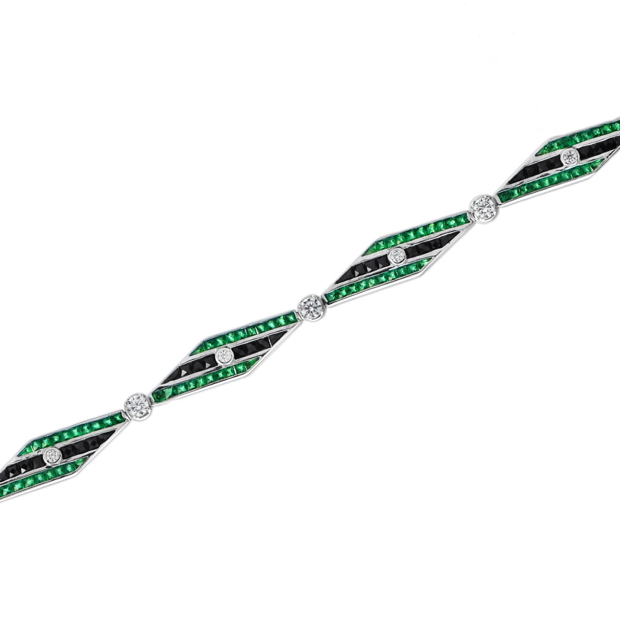 This Art Deo design bracelet is exceptional! It features 18k white gold links set with round diamonds, square-cut onyx, and emerald. This piece closes with a concealed clasp and safety catch.  Given the outstanding quality and beautiful design of