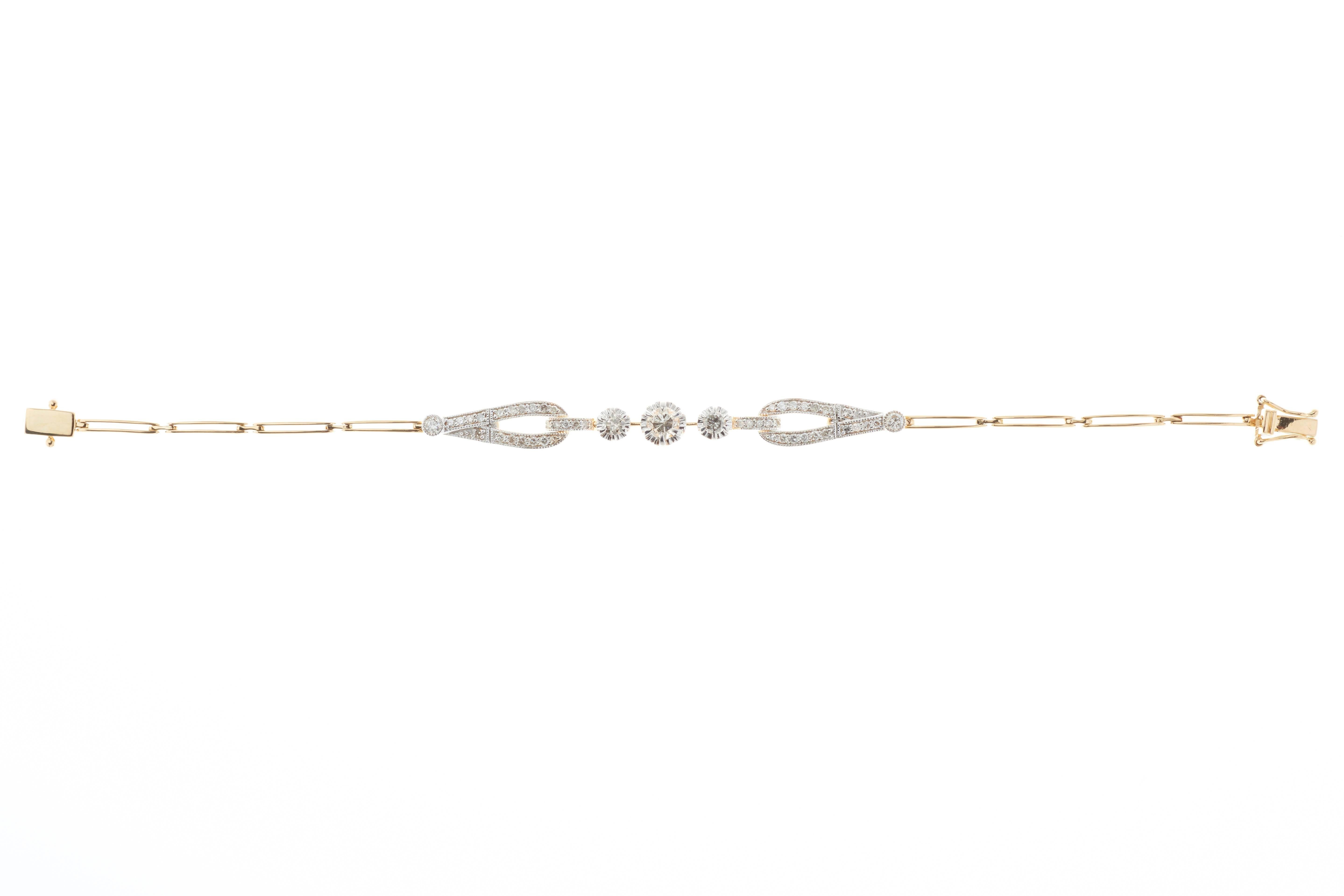 Art Deco Style Diamond Bracelet by Emily Sam Collection - Designers

Diamond total 1.04 Carat all Round Brilliant:
1 Central Round Brilliant  Diamond is 0.34 Carat
2 Shoulder Diamonds 0.22 Carat
46 Diamonds 0.48 Carat
18 Carat Two Tone Yellow and