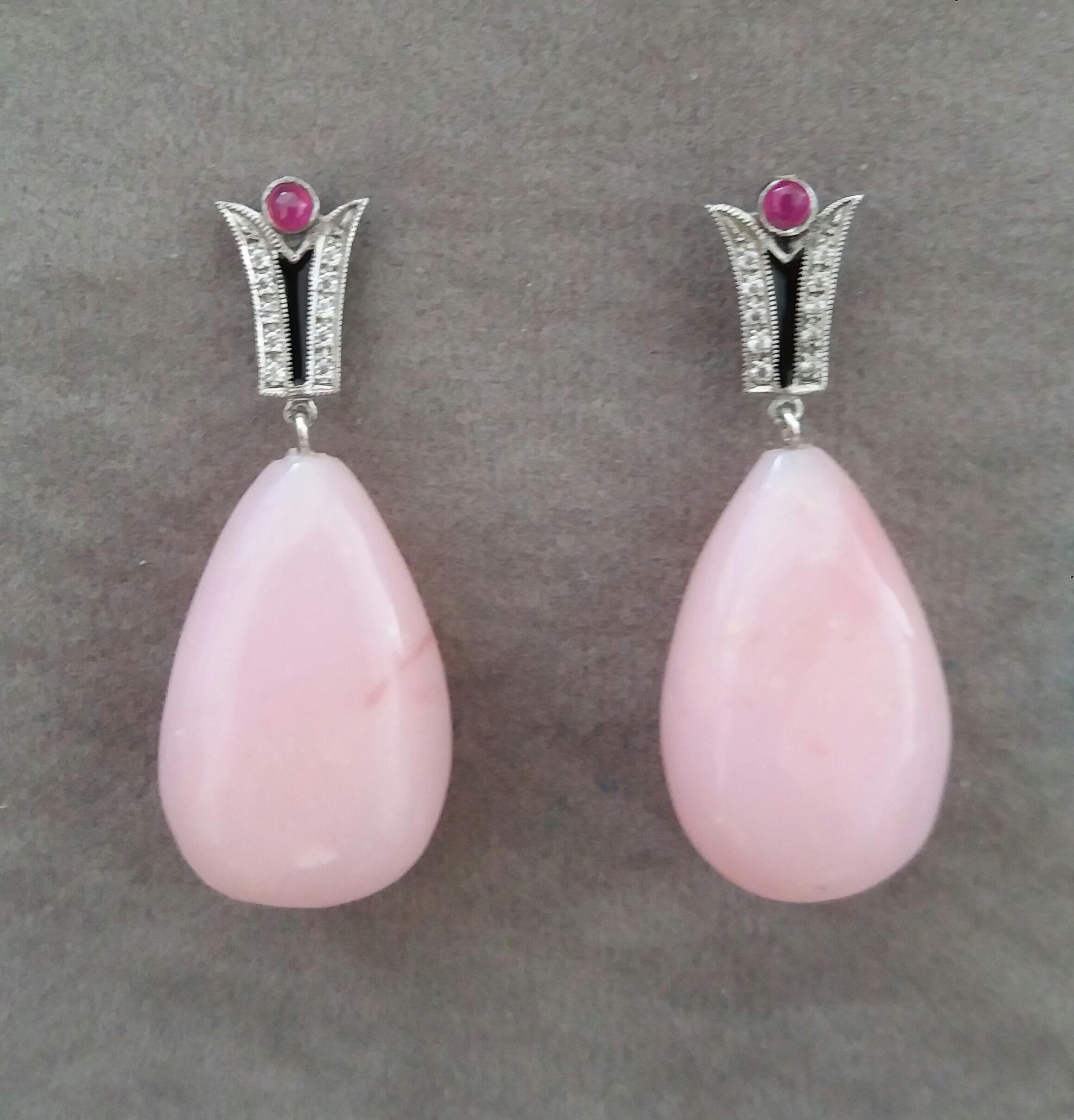 In these classic Art Deco Style earrings the tops are 2 elements  in 14 kt. white gold, 20 round full cut diamonds,black enamel and small round Ruby cabochons ,in the lower parts we have 2 very good color Pink Opal plain drops  measuring 16 x 25 mm