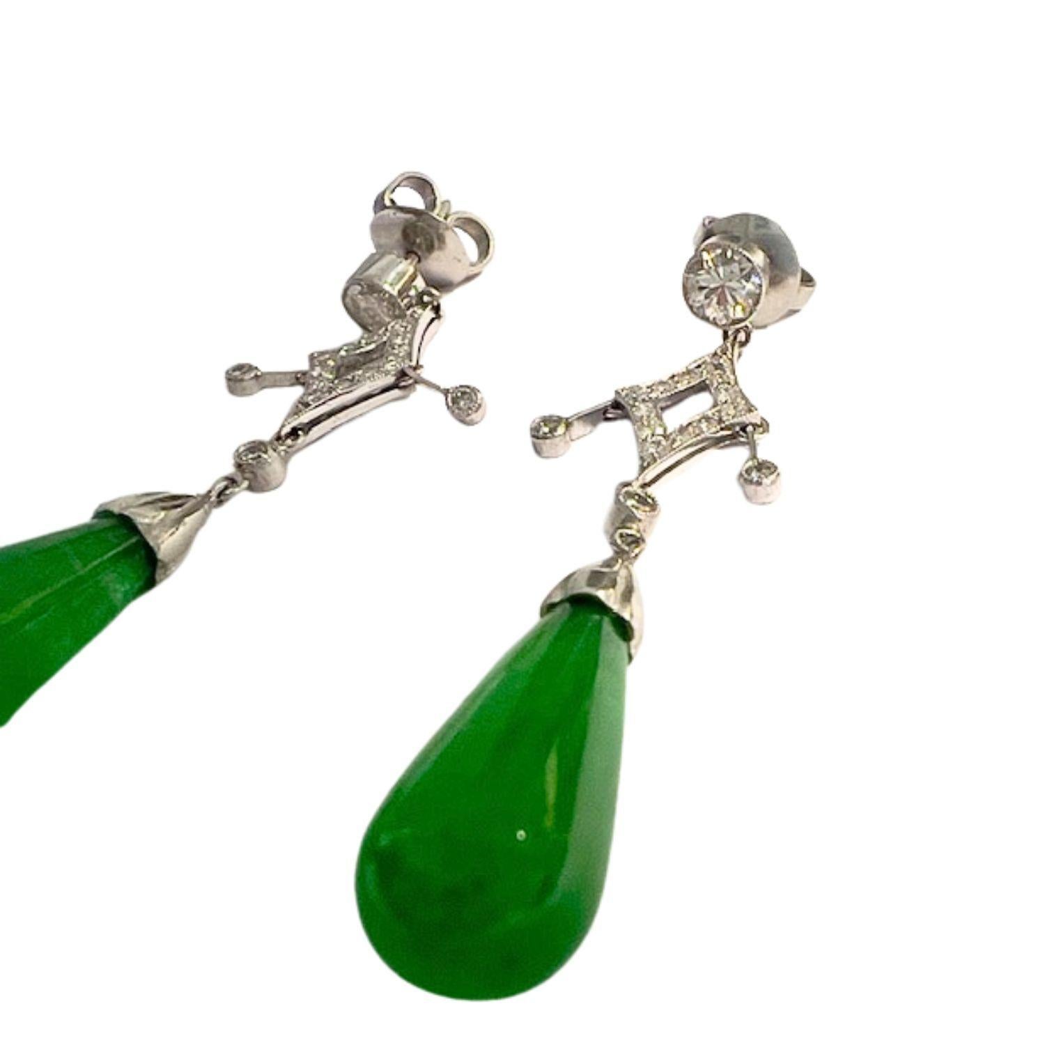 These long earrings embody the Art Deco style, crafted from Platinum 950. They feature Diamonds and Jadeites, offering a sophisticated look. 
The Diamonds, totaling 1.35 carats, include 0.30 carats of VS1-VS2 clarity with H-I color grade and 0.75