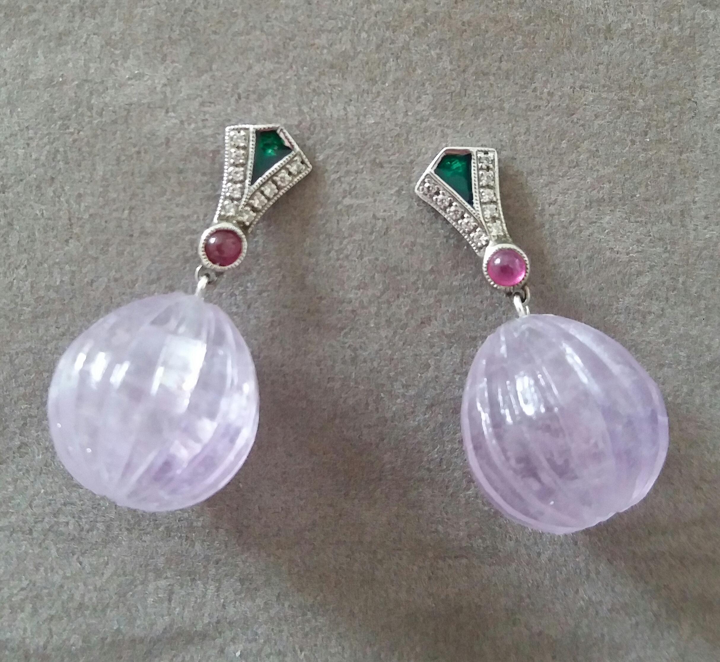 In these classic Art Deco Style earrings the tops are 2 elements  in 14 kt. white gold, 20 round full cut Diamonds,Green Enamel and small round Ruby cabochons ,in the lower parts we have 2 Amethyst Carved Round Drops  measuring 15 x 15 mm and