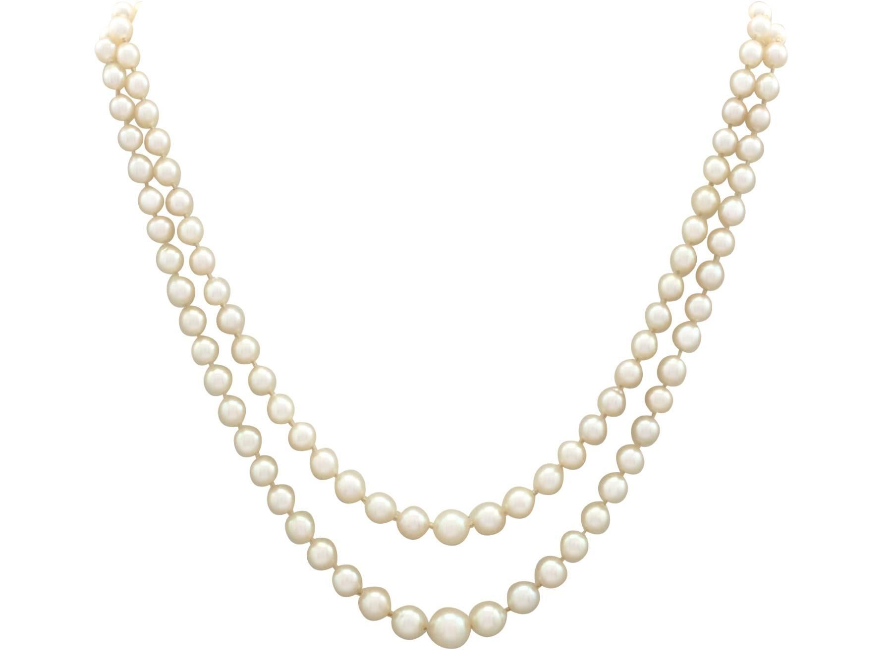 An impressive double strand pearl necklace with imitation stone, 0.43 carat diamond and 18 karat white gold, platinum set clasp; part of our diverse pearl jewelry collections.

This fine and impressive vintage double strand pearl necklace has been