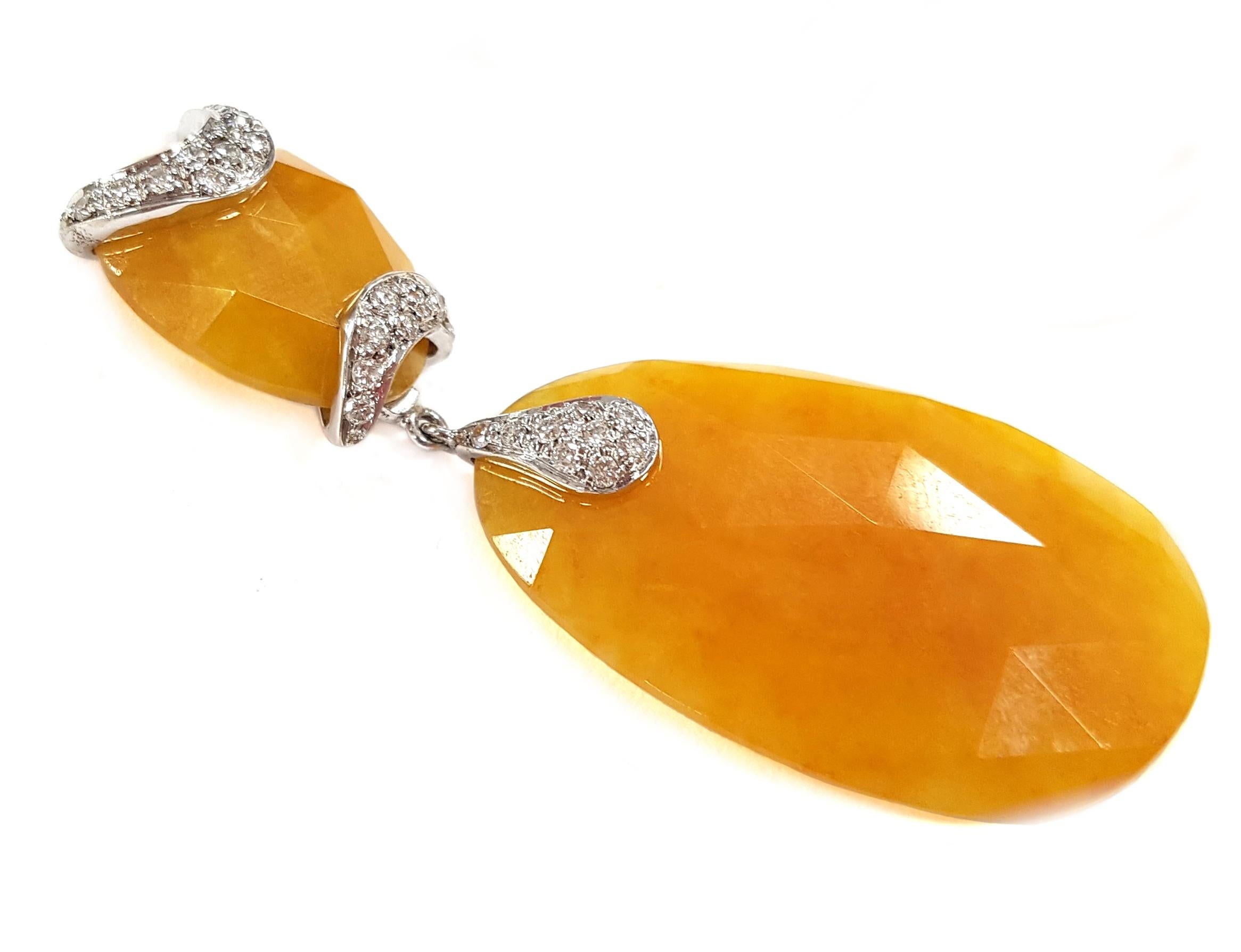 These golden yellow jade and 18-karat white gold earrings feature pavé-set white diamonds (0.48 carats); they are in the style of Art Deco. In-person, the yellow is slightly softer/lighter than in the photographs. 

Jade is believed to bring luck,