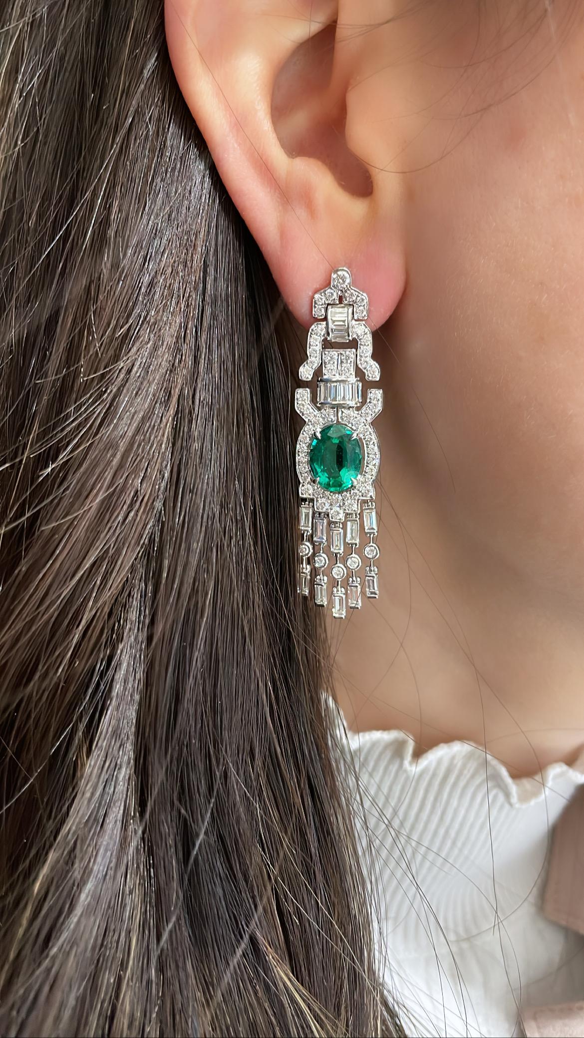 Art Deco Style Emerald and Diamond Drop Earrings 9 Carat
These elegant art-deco style earrings stand out with beautiful oval green emerald stones at the center totaling in 5.01 carats. Stunning round and diamond baguettes totaling 4 carats encrust