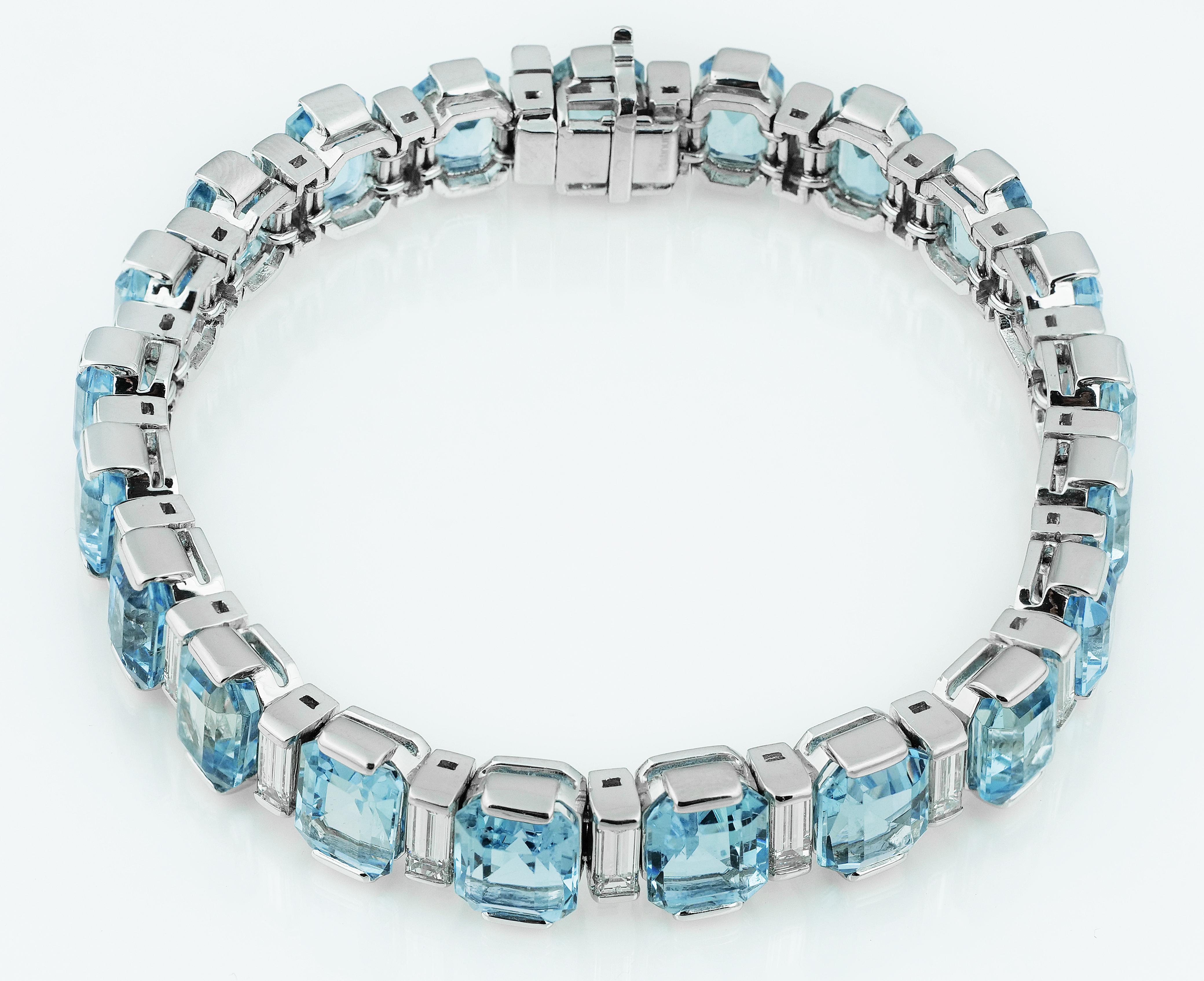 Stunning aquamarine and diamond bracelet with hidden box clasp. Alternating emerald cut clear sky blue colour aquamarine and baguette cut diamonds set in platinum. 
21 x Aquamarine approximate total weight 34.0 carats
21 x Baguette cut diamond,