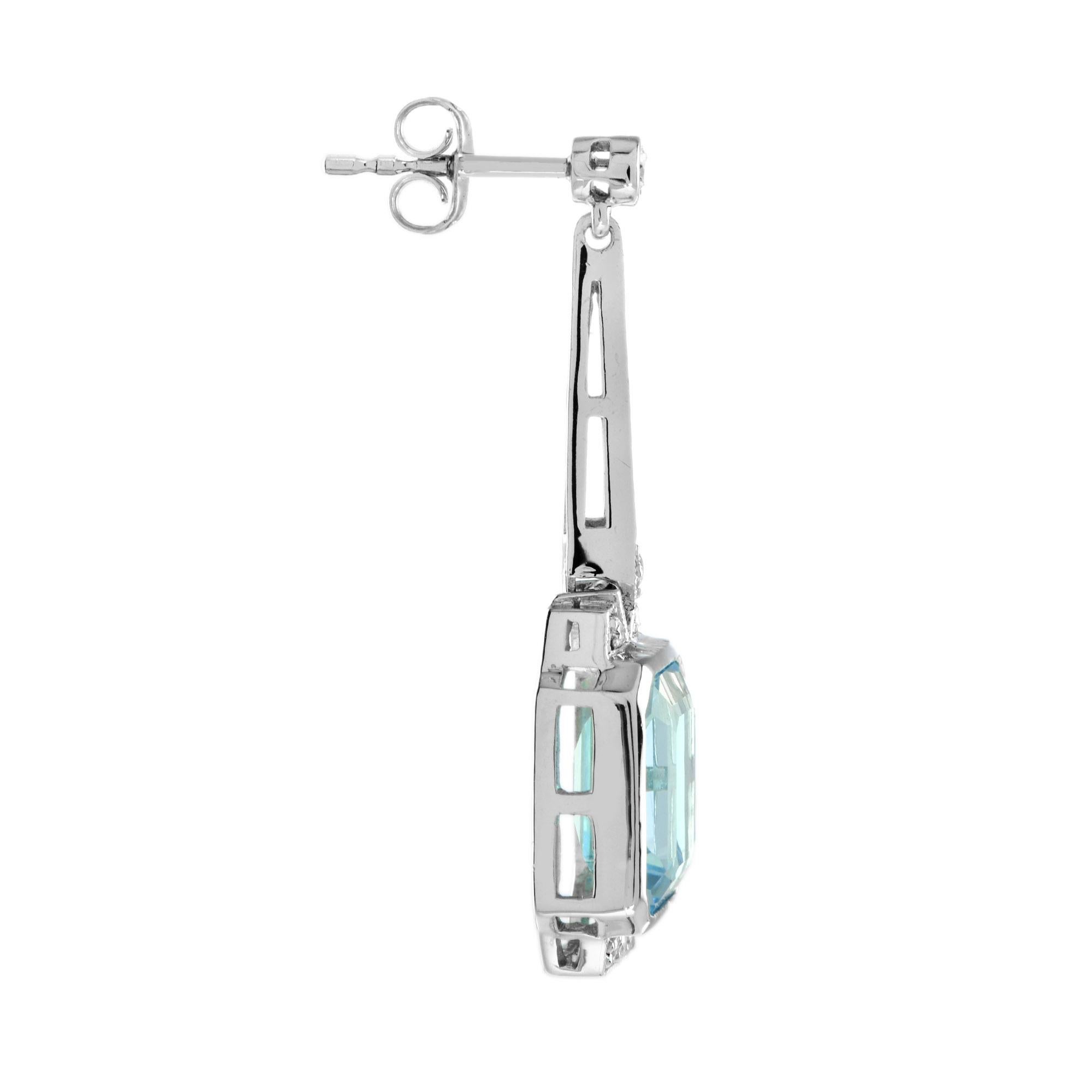 Express yourself with these insanely stylish, stunningly detail earrings with emerald cut blue topaz and diamonds. Match them with your favorite outfit to complete your look. 14K White Gold. 
Information
Style: Art Deco
Width: 9 mm.
 Length: 35 mm.
