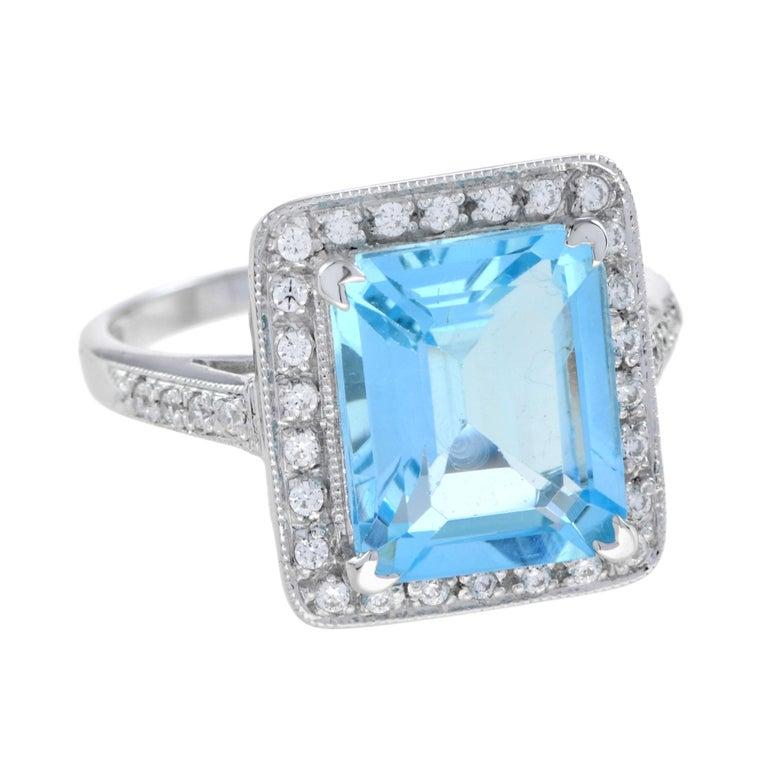 The signature emerald sky blue topaz ring features diamond halo in a cathedral setting. Accenting the center gem with diamond half way down the band. This exquisite ring is a wonderful addition to your fine jewelry collection.
Ring