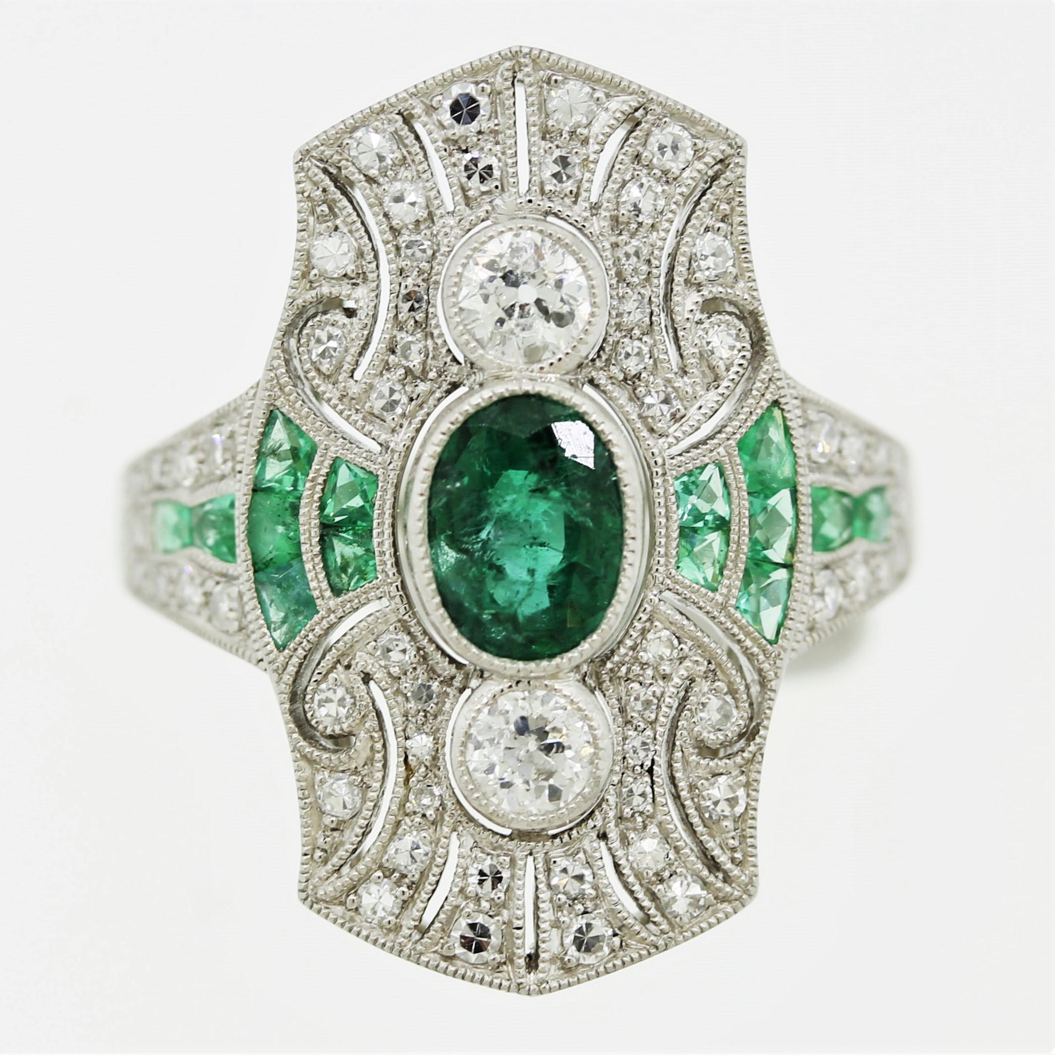 A new ring designed and crafted in original Art Deco style from the 1920’s. It features a large oval-shape emerald in its center which is accented by smaller french-cut emeralds set in its sides. Addings brilliance and sparkle are european-cut
