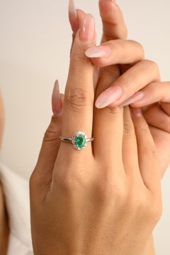 0.73 Carat Oval Emerald Engagement Ring with Halo Diamonds in 14k White Gold